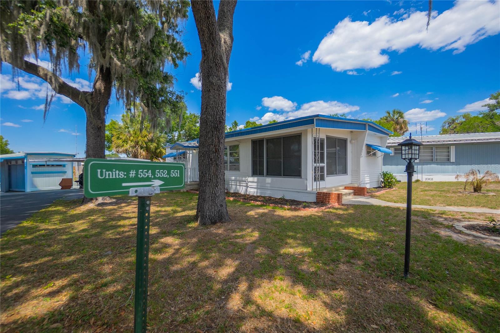 If low maintenance living with a side of lake life sounds appealing, this one is worth a look. This 2 bedroom, 1.5 bath mobile home is located in a 55+ community that keeps things simple while still offering plenty to enjoy. The home comes fully furnished, making it an easy transition whether you are moving full time or just looking for a seasonal escape. Inside, you will find a comfortable layout with a spacious living area, dining space, and a screened porch that is perfect for morning coffee or winding down in the evening. The home has tie downs, it was painted 2 years ago, and the roof was sealed 5 years ago (2021). The monthly HOA fee of $181 covers water, trash, and access to community amenities including a pool, clubhouse, dog park, and library. For those who enjoy being on the water, residents have direct access to Lake Griffin, and an optional covered boat slip with lift is available for just $45/month.There is also potential for a golf cart to be included with an acceptable offer, adding even more convenience for getting around the community.Easy living, water access, and everything you need already in place. All that is missing is you.