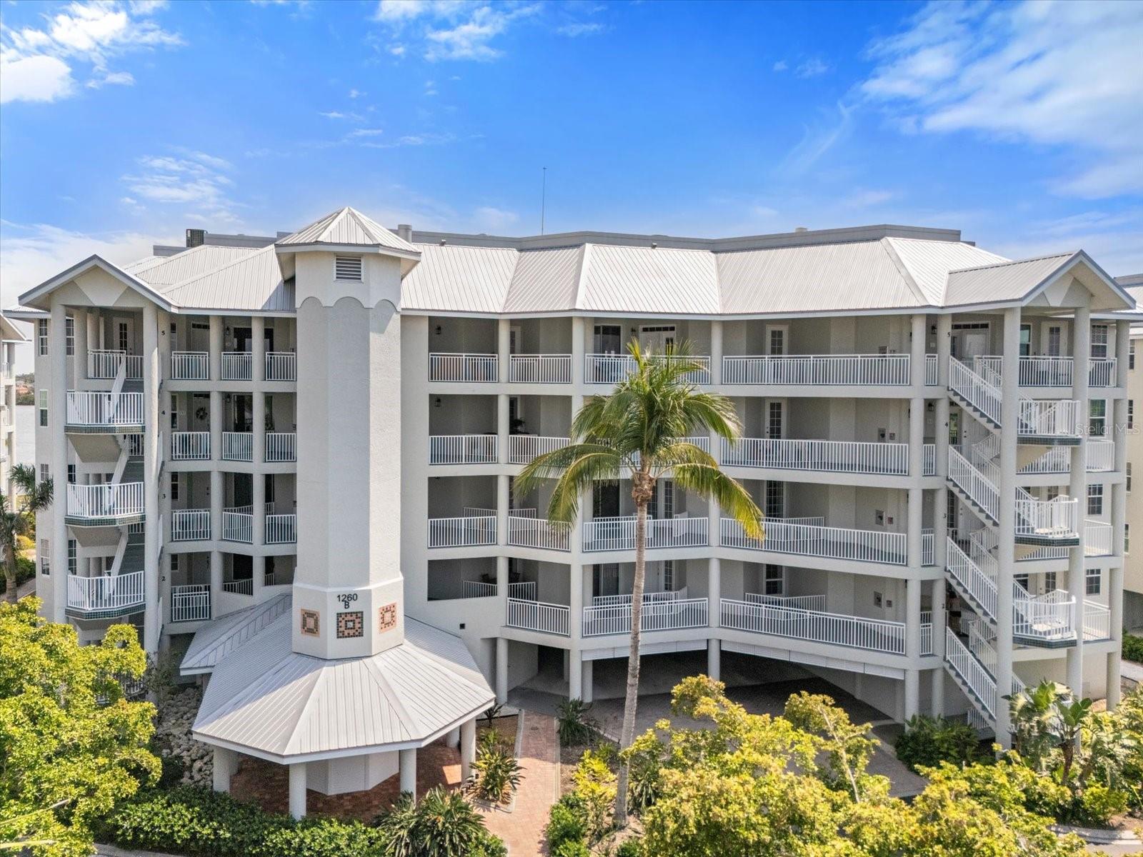 ENJOY SERENE INTRA-COASTAL WATER VIEWS from this this 4th floor, end unit, 3 bedroom, 3 full bath condo at Dolphin Bay. This community lives life to the fullest! Lots of social activities and friendly and caring neighborhood. Take a new look and enjoy the fresh new decor and new high impact windows and sliders, all added in 2025! Reduced condo fees. This meticulously maintained condo lives like a single family home with charm and character. The kitchen was custom built by Yoder Construction, a well-known local company, highly respected for their craftsmanship. Living room and dining area are bright and spacious. The large primary bedroom has a walk-in closet and ensuite with shower and separate soaking tub. There are two other ensuite bedrooms. All three bedrooms have California Closet systems. All windows have custom plantation shutters, adding to the charm and comfort of this amazing condo. You will want to spend your day on the light filled lanai, perfect for entertaining or simply relaxing. Dolphin Bay is a highly desirable, gated, pet friendly, 50-unit complex with a fun filled community atmosphere with three Har-Tru tennis courts, an active clubhouse, fitness center, pool and spa, day dock, fishing pier and kayak access. Dolphin Bay is well maintained with a freshly updated exterior and new elevators in 2024 and beautifully landscaped grounds. Just a short walk to the world famous, white crystal sands of Siesta Key beach.