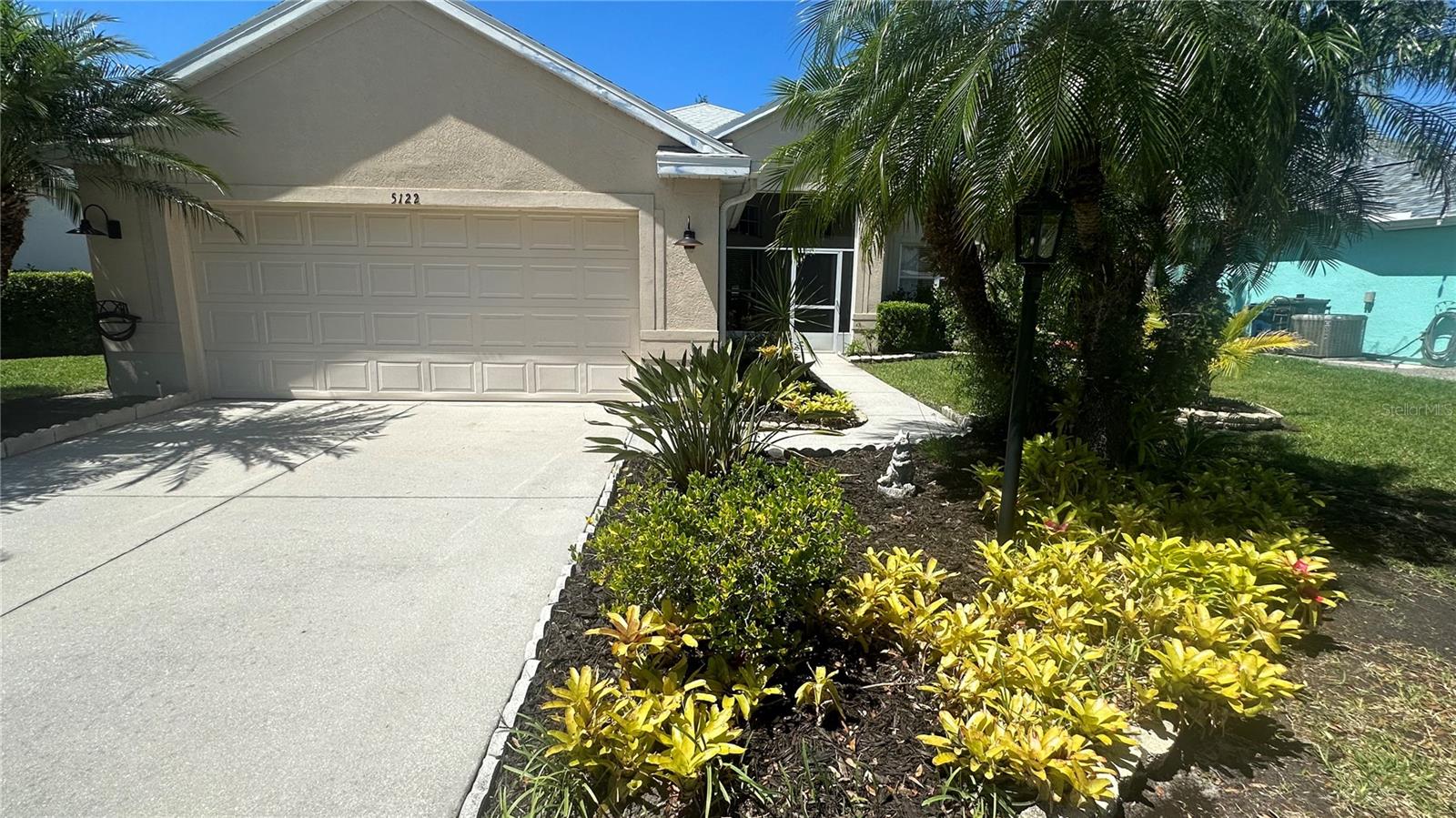 Welcome to the highly, sought-after community of Carlyle at The Villages of Palm-Aire, which is strategically located in North Sarasota near the Palm Aire Golf & Country Club. Click on the Virtual Tour Link 2 for a 3D/360 view of this property. In this quaint and secluded community, this property provides the perfect blend of elegance, style, and serenity featuring a recently updated 3-bedroom, 2-bathroom home, and 1800 square foot home which includes a formal dining room with custom, glass-paneled French Doors, an Air-Conditioned Safe Room, a spacious 2-car garage and a vinyl, privacy fenced yard for your pets.  Recent updates include a 2026 Gas Hot Water Heater, a 2025 Roof with a transferable warranty, new Kitchen Aid Stainless-Steel Refrigerator and Dishwasher, a Broan Range Hood, Fresh Paint throughout the home, new Ceiling Fans and Landscaping. The Open Floor plan encompasses the chef's kitchen with a breakfast bar, granite countertops, an eat-in space, a large island for food preparation, a GE (5)  burner gas stove, a GE Profile Built-In Convection Oven and Microwave Oven and custom cabinetry including (4) Glass Door Cabinets with pull Up Doors, a roll-out trash cabinet and a Lazy Susan lower cabinet. The kitchen intertwines with the living room providing an excellent option for family gatherings and entertaining.  The split floor plan offers privacy and functionality, with the primary suite providing a peaceful retreat complete with a double vanity, new lighting, a soaking tub, shower and a custom-built, walk-in closet. The guest bathroom provides direct access to the lanai for you and your guests while entering on the lanai.  The laundry is separated from the kitchen with a pocket door and is equipped with brand new LG Thin Washer and Dryer appliances with additional storage cabinets. Step outside to your backyard paradise—a plant lover’s dream—with a large, screened and covered lanai, fountain pond water feature, and lush landscaping that creates a serene retreat for relaxing or entertaining. Located in an amenity-rich community, you’ll enjoy pickleball, tennis courts, a sparkling community pool, and a playground. Ideally situated near the vibrant University Parkway/UTC Mall corridor, this home is just minutes from Downtown Sarasota, St. Armand’s Circle, and world-class beaches. Sarasota International Airport is only 15 minutes away, ensuring effortless travel. With its excellent location, thoughtful upgrades, and community perks, this home is a rare find. Schedule your private tour today and start LIVING YOUR BEST FLORIDA LIFE ON THE GULF COAST!