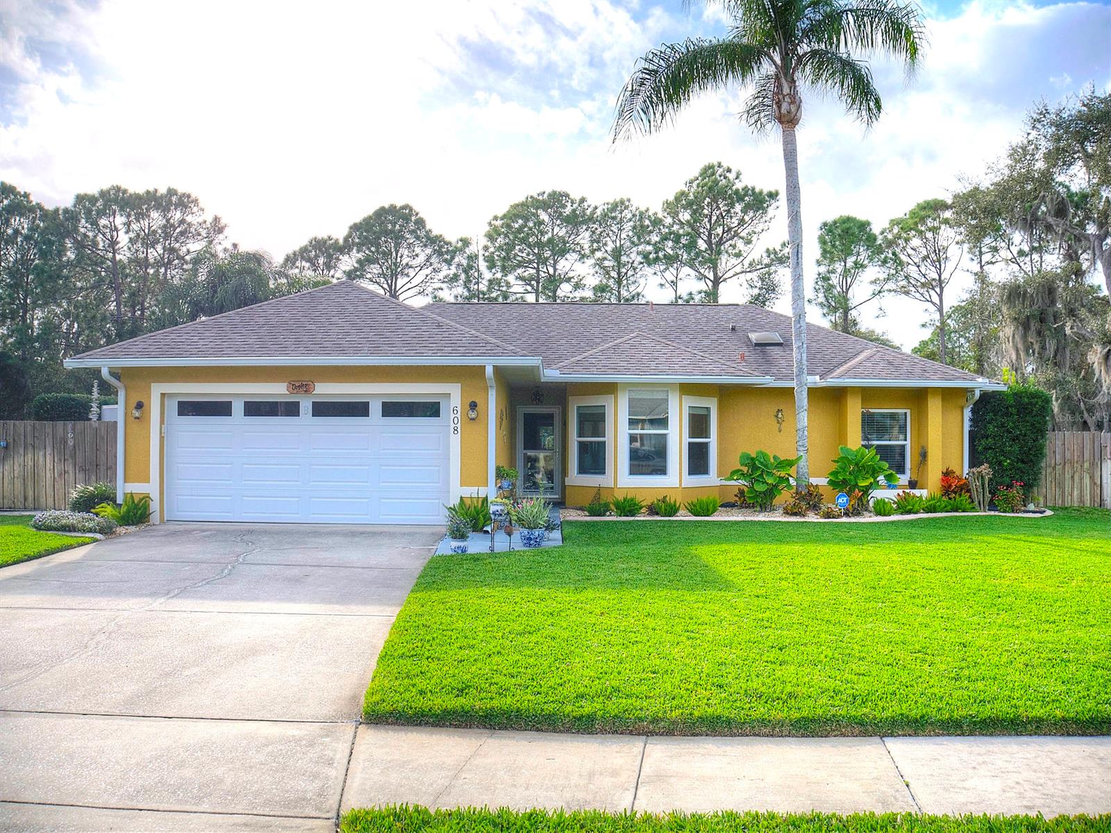 Beautiful in ground pool home located in the quaint subdivision of Windsor Colony with NO HOA is waiting for a new family. This 3 bedroom 2 bath, 2 car garage, concrete block home has lush landscaping and ample parking for all your vehicles. The interior features high ceilings and custom tile flooring in the main living area. The nicely redone eat-in kitchen offers a new, full appliance package as well as a bay window. Your master bedroom has wood flooring , a large walk-in closet and an updated bathroom. Step out back into the beautiful, fenced yard which feels very private and take a dip in your sparkling pool! Recent (past 4-5 years) upgrades include; New vinyl insulated windows/slider. Solar wrap insulation and attic fans, water heater, garage door, fence and pool heater. ;Water: City
