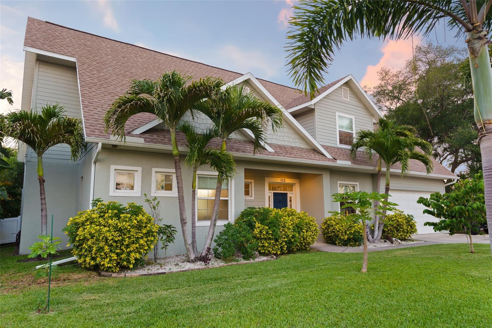 This beautifully crafted 4-bedroom, 3-bath home with a bonus room offers timeless design paired with modern functionality. Built in 2014, it features soaring 20-foot ceilings, rich oak staircase accents, and wood-look porcelain tile that creates a refined yet durable foundation.

The open-concept layout is ideal for entertaining and everyday living. At the heart of the home, the kitchen is designed for connection and conversation, featuring custom cabinetry, granite countertops, stylish backsplash finishes, and a natural gas range. It flows seamlessly into the dining and living areas, making it ideal for gatherings and daily life.

The first-floor primary suite offers dual walk-in closets and a spa-inspired ensuite bath with dual vanities, soaking tub, oversized shower, and private water closet. An additional downstairs bedroom with full bath provides flexibility for guests or a home office. Upstairs includes two spacious bedrooms and a large game room.

Extensively ENHANCED with approximately $155,000 in UPDATES completed between 2023 and 2026, the home includes a CUSTOM BUILT IN OFFICE, NEW BATHROOM CABINETS, UPGRADED MIRRORS AND SHOWER FINISHES, REDESIGNED LAUNDRY WITH ALL NEW CUSTOM CABINETS, UPDATED COUNTERTOPS, CUSTOM CLOSETS, DESIGNER WINDOW COVERINGS, FRESH INTERIOR PAINT, MODERN LIGHTING FIXTURES, UPDATED ELECTRICAL COMPONENTS, NEW DISHWASHER, MICROWAVE, DECORATIVE FOUNTAIN, UPDATED LANDSCAPING INSPIRED WITH THE LIVE OFF THE LAND mantra, SCREENED CAGE ENCLOSURE, POOL, WALLPAPER ACCENTS, and additional thoughtful finishing touches.

Large hurricane-rated sliders open to a private outdoor lanai, saltwater POOL, landscaped backyard, and sunset skies just moments from the Gulf. The outdoor space was designed to embrace any lifestyle, from entertaining to quiet evenings.

Additional highlights include: easy attic access, engineered hardwood flooring, oversized storage areas, and tall ceilings throughout blend beauty with practicality. The oversized garage provides ample room for bikes, kayaks, golf carts, and all the gear that comes with an active Florida lifestyle. Boat owners will especially appreciate the side parking and close proximity to public boat ramps.

Perfectly positioned just blocks from Sunset Beach and less than half a mile from Fred Howard Park, this location offers the rare combination of coastal living in a NON FLOOD ZONE and appreciate the convenience of nearby highly regarded schools, all within walking distance. Located in the heart of vibrant Tarpon Springs, residents enjoy a true sense of community with monthly downtown events, waterfront concerts, exceptional local dining, and the world-famous Tarpon Springs Sponge Docks just minutes away.