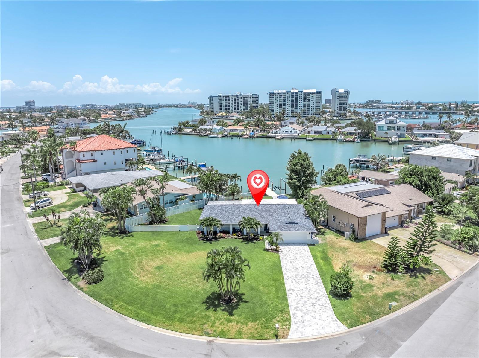 Some homes check every box — this one adds a boat lift. Set on an oversized corner lot in the Paradise Island subdivision of Treasure Island, FL, this 3-bedroom, 3-bath single-family pool home offers direct canal-front access to the Intracoastal Waterway with no HOA. The 2-car attached garage, 1,828 sq ft of heated and cooled living space, 460 sq ft of covered outdoor space, and a 3rd full bath with interior laundry room make this one of the most functional waterfront floor plans on the market.
Expansive hurricane-impact windows and sliders (2024) fill the open-concept living area with panoramic water views. New 40x40 tile flooring (2025) runs throughout. The modern kitchen features quartz countertops, custom wood cabinetry, stainless appliances, and a dry bar. The split-bedroom layout provides privacy for every guest, and a dedicated ensuite off the guest bedroom adds flexibility for multi-generational living.
The primary suite overlooks the pool and water, with direct patio access and a spa-inspired bath featuring a freestanding soaking tub and rain shower within a glass-enclosed wet room, dual vanities, and matte black fixtures.
Outside, a resurfaced Pebble Tec pool, new paver deck (2025), composite dock with 10,000 lb boat lift, and new seawall deliver deep-water access to the Intracoastal — minutes to the Gulf by boat. Additional upgrades include roof (2018), HVAC (2018) with new coil (2024), new electrical panel, copper rewire, hurricane-rated garage door, upgraded insulation, bathroom remodels, new interior doors, baseboards, soffits, fascia, and light fixtures throughout.
Minutes to Treasure Island Beach, and down the street from the 17-acre Treasure Bay waterfront park — golf, tennis, playground, a walking trail, and a newly completed living shoreline with kayak and paddleboard launch, all within the neighborhood. From there, the barrier island lifestyle takes over. Bike or golf cart from Pass-a-Grille to Clearwater Beach, hit the dog park, play pickleball or spend an evening in Downtown St. Pete — all without getting on the highway. On the water, the options are endless: waterfront restaurants, waterside groceries, bars, and Downtown St. Pete all reachable by boat. This is Florida living at its best. Easy to show.