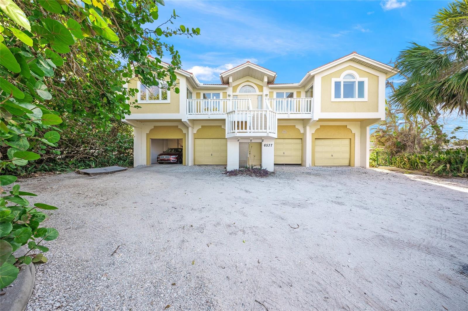Gulf views from this elevated spacious and bright block home built by Whitehead Construction on an oversized 17,000-plus-square-foot lot with beach access just a short distance away. This smartly designed home features all living areas on one level and offers four generous sized bedrooms, all with en-suite baths. You will love the large chef's kitchen with views to the outside, plenty of cabinetry and a breakfast bar. The open plan offers wonderful flow for entertaining and opportunities for multiple gathering areas. Sliders lead to a spacious outdoor living area overlooking the pool and Gulf of Mexico. And for ease of living, each side of the home has its own laundry area. Bring your imagination as downstairs offers room for multiple cars, storage, a shop or hangout area off the pool.  On the north end of Longboat Key, this home backs up to Gulfside Drive with beach access at the south end of the street. This home is block all the way up.