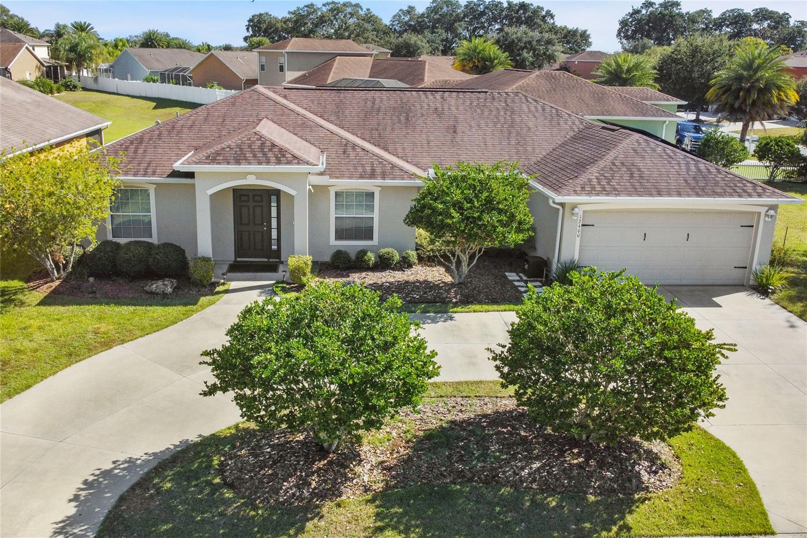 OFFERING $2000 TOWARDS BUYERS CLOSING COSTS WITH PREFERRED LENDER!!! Welcome to your dream home in the multi-generational community of The Villages of Parkwood in Oxford, FL! This stunning 4-bedroom, 2 1/2-bath residence is a true gem, offering a perfect blend of elegance, comfort, and modern features. Situated on an oversized (double), corner lot, this property boasts a grand presence with a circular driveway that welcomes you home in style.
The high ceilings create a spacious and airy atmosphere, complemented by the new, luxurious vinyl plank flooring, providing both durability and a contemporary aesthetic.

The heart of this home is undoubtedly the open, well-designed living area, where you can entertain guests effortlessly or gather in the formal dining area for more intimate occasions.  The kitchen features a breakfast bar, modern appliances, granite countertops & a spacious pantry.  There is also an eat-in area that shares space with the living area.

Escape to the private sanctuary of the master suite, featuring a tray ceiling and a spa-like ensuite bath and ample closet space. Three additional bedrooms provide versatility for guests, a home office, or a growing family.  Step outside to discover the fenced-in yard as well as a beautiful back patio, adorned with Italian stone, that is the perfect spot for al fresco dining, morning coffee, or evening relaxation. Imagine hosting summer barbecues or simply unwinding in your own outdoor oasis.  

This residence is not just a home; it's a lifestyle. Don't miss the opportunity to make this property yours. Contact us today to schedule a private showing and experience the allure of this Oxford, FL haven.  NOTE: Owners have paid for solar panels in full & they convey with the home (Installation: March 2020).  October 2023 electric bill was only $28!!!