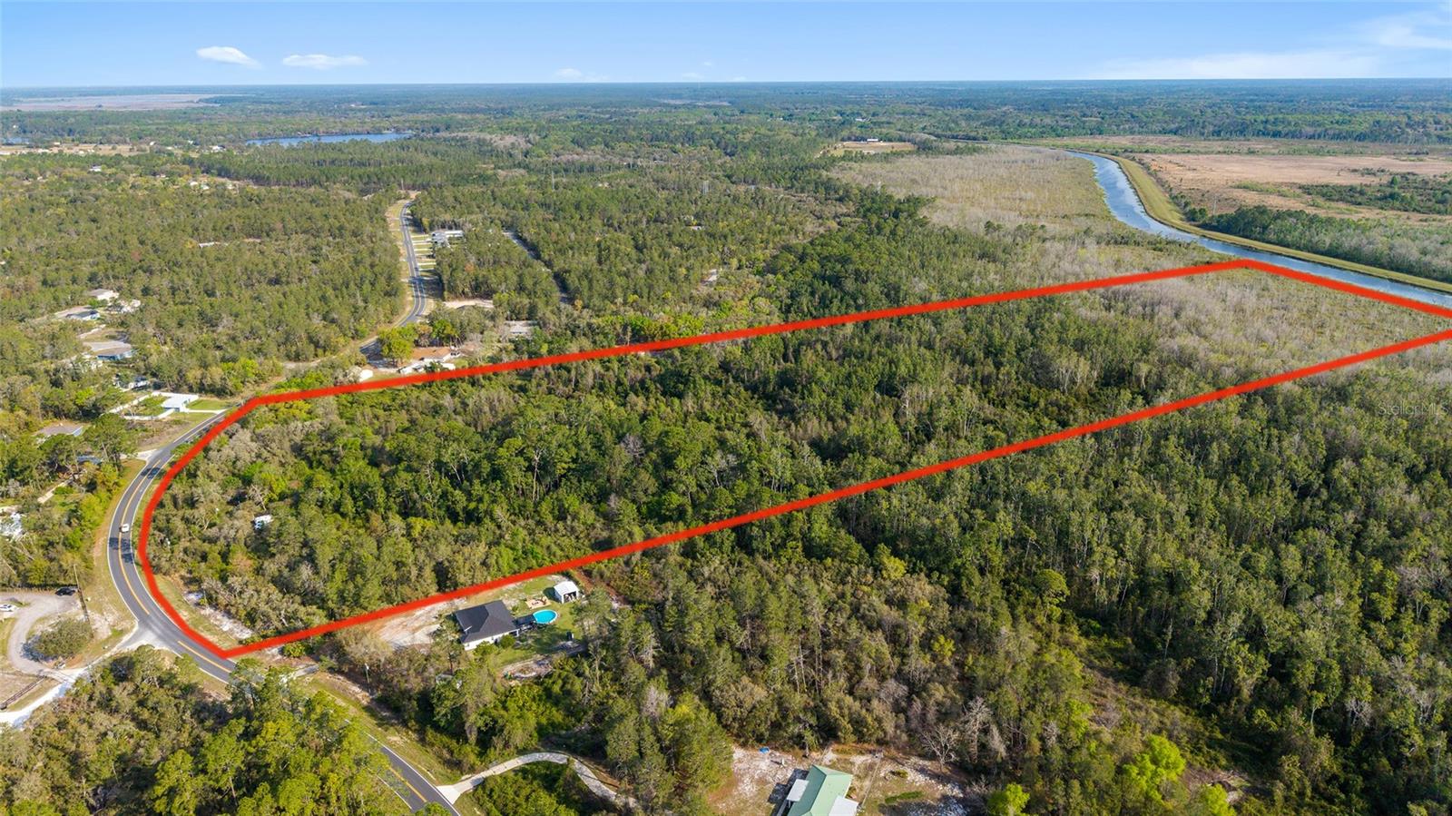 Welcome to your private escape nestled in the heart of Ocklawaha! Situated on a diverse and tranquil 39.31 acres, this property offers a rural setting with over 600' of newly paved road frontage and over 700' of Ocklawaha River frontage, with legal access. Whether you're looking for a peaceful homestead, a weekend getaway, or a place to build your dream lifestyle, 475 Fisher Rd delivers. It's close proximity to the Ocala National Forest as well as being only minutes away from Lake Weir, and all the modern amenities The Villages offers makes this property ideal for any number of possibilities. The property does include a nearly 1,800 SF manufactured home which would need extensive renovations, however also comes equipped with a septic system and well ready to go. Running thru the property is a charming little creek, fed by Bear Lake located directly across the street. Enjoy the freedom of having plenty of space surrounded by nature for exploring, adventure, and expansion. No HOA, zoned A1,  all opportunity. Bring your vision and make 475 Fisher Rd your next great investment or forever home.