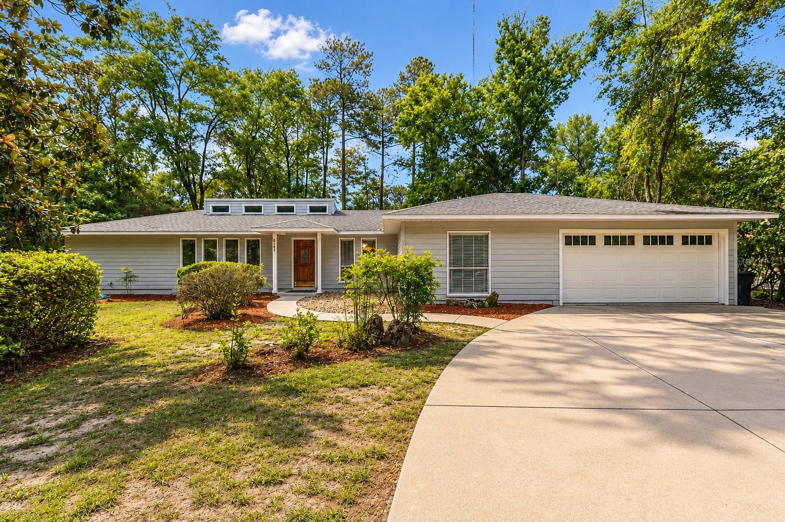This well cared for pool home is located in the Deer Run subdivision directly off Millhopper Road, the property offers a rare and permanent connection to the outdoors, as it backs up directly to Devil's Millhopper Geological State Park.  Move-in condition, featuring a freshly painted interior and exterior, along with brand-new carpet throughout the living and bedroom areas.  Wood floors in kitchen and dining areas.  Designed for modern living, the functional open floor plan includes split bedrooms, a vaulted ceiling and skylights in the great room anchored by a handsome stone fireplace and hearth, an open kitchen with breakfast bar, dining area and bonus flex space with built-ins all complemented by ample natural light throughout the home.  Convenient inside laundry room with ample storage space.  The exterior is highlighted by a spacious covered rear porch and a caged pool area with new indoor outdoor carpet applied to the covered patio, and the pool area features a convenient direct-access bathroom.  Bonus storage shed on concrete slab and bird feeding station all setup and ready to please - just add feed.  A short walk or bike ride to San Felasco Nature Park with nature trails, playgrounds and picnic areas and close proximity to Hunter's Crossing Shopping Center, dining options and Talbot Elementary school.  Hurry this one won't last!
