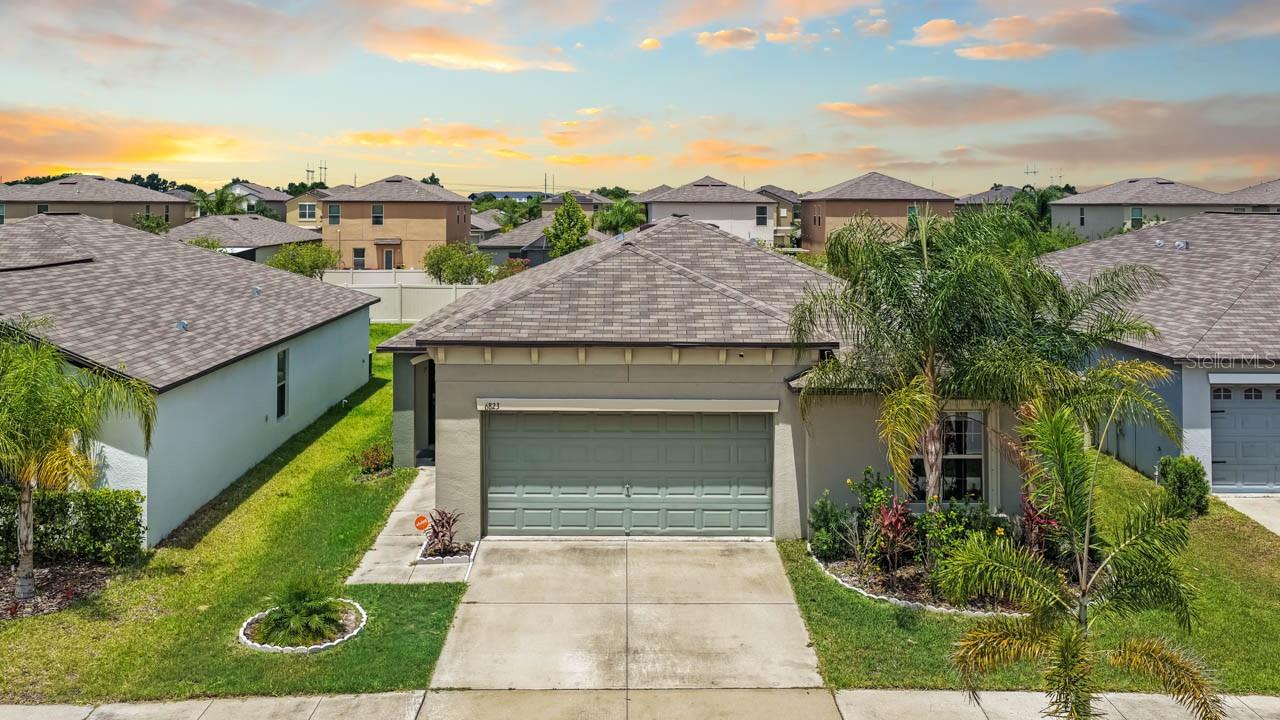 One or more photo(s) has been virtually staged. Welcome home to this beautiful 4-bedroom, 2-bathroom residence, offering the perfect blend of modern Florida charm, effortless maintenance, and ultimate peace of mind. Step inside to an expansive, light-filled open-concept floor plan that seamlessly connects the living spaces for easy entertaining and everyday comfort. Your living experience extends outdoors to a spacious, partially fenced backyard featuring lush, producing mango trees ready for a seasonal harvest, all kept vibrant by an integrated sprinkler system. Designed with convenience and safety at the forefront, this turnkey home comes fully equipped with full hurricane shutters and a premium, upgraded alarm system to give you complete security and confidence year-round. Beyond the property line, the community amenities elevate your lifestyle even further, offering exclusive access to a sparkling community pool, a vibrant playground, and a welcoming clubhouse perfect for gatherings and neighborhood events. Schedule your private tour today and taste the sweet life at King Creek Drive!