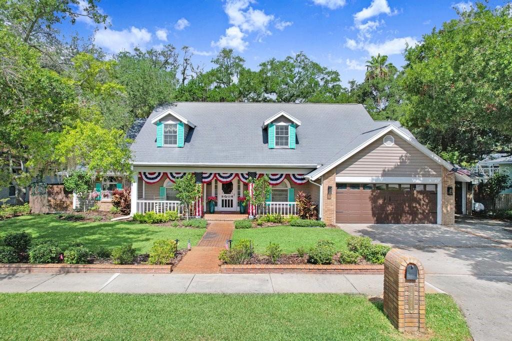 This home is a complete gem. You cannot duplicate this property, as it is nestled on an oversized 0.60-acre lot in one of Dunedin's most coveted enclaves. This exceptional waterfront residence embodies the rare marriage of timeless charm and spacious living. Majestic oak trees frame the property, while expansive, beautifully landscaped grounds set the stage for the dream that awaits. A wide front porch welcomes you upon arrival, offering plenty of space for rocking chairs and quiet mornings. Upon entering, a spacious hacienda-style first-floor layout reveals a gorgeous great-room floor plan with a fireplace and multiple sets of French doors that wrap around the home, providing beautiful views of the spring-fed lake and opening to the expansive enclosed pool, spa, and patio area. The custom kitchen includes ceramic tile floors, beautiful custom cabinetry, a center island, and granite countertops. High-end appliances complete the kitchen, along with a built-in desk and walk-in pantry. The oversized primary bedroom measures 14' x 37' and includes an area that can be used for exercise, yoga, an office, or a quiet sitting area. French doors lead out to the pool and patio area with views of the lake. The luxurious en-suite primary bath boasts a steam shower, separate his-and-her vanities, and a large soaking tub. The enormous primary closet is fully customized cabinetry, built-in drawers, and abundant storage. Off the kitchen is a large bonus room with direct pool access through French doors that can effortlessly transform into a bedroom, game room, art studio, or whatever your imagination desires. The oversized laundry room includes custom built-in cabinetry and a utility sink. There is also an office with uniquely designed custom cabinetry and a centrally located half bathroom. Upstairs, you will find three additional large bedrooms with dormer windows and plenty of closet space. The full bathroom is beautifully appointed. Step outside to your oversized pool and heated spa, surrounded by quartz tile pavers and completely enclosed within a screened lanai spanning 1,992 square feet. Multiple seating areas provide plenty of places to relax and entertain. Beyond the pool area lies your own private backyard sanctuary. Beautiful, mature oak, mango, Florida apple, and banana trees line a brick-paver path leading to the spring-fed lake, fire pit, and floating dock. You may spot otters, owls, and herons that call this area home. A large three-car garage provides ample space for vehicles, a golf cart, storage, or a workshop. Recent updates include a new spa heater, a whole-home generator installed in 2022 with its own propane tank, two new A/C units installed in 2025, freshly sealed pavers around the pool deck, and a 10-year roof sealant. Location! Ideally situated near Honeymoon Island State Park, the Pinellas Trail, and downtown Dunedin's charming shops, restaurants, and entertainment. The location even allows you to drive your golf cart into downtown Dunedin. This home is unique, unforgettable, and far from the typical cookie-cutter Florida property. A must-see!