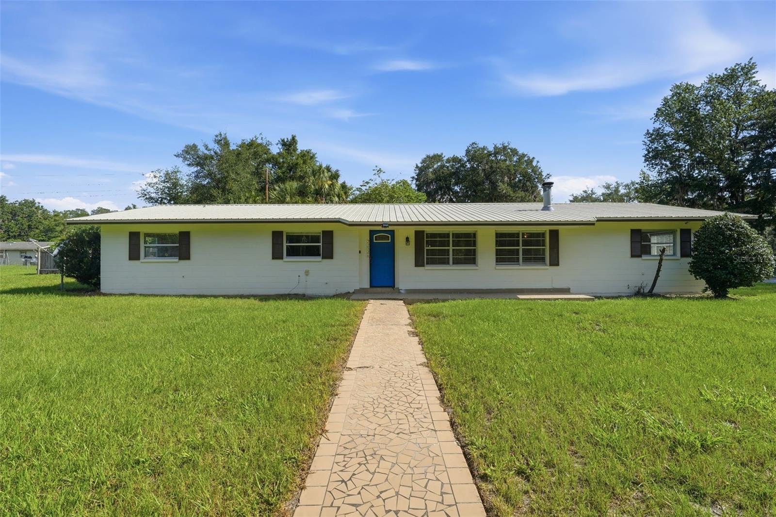 5 bedroom, 3 bathroom home with PRIVATE POOL and on fenced-in 1/2 ACRE! This BLOCK constructed home features NEW LUXURY VINYL FLOORING, FRESH INTERIOR PAINT, a METAL ROOF and STAINLESS STEEL kitchen appliances. The living room features a fireplace, creating a comfortable gathering space. The backyard is built for enjoying Florida living with a PRIVATE POOL that has been extensively updated, including a NEW MOOV variable-speed pool pump and motor, new 100 sq. ft. Pentair filter housing, new cartridge filter, new plumbing, and a recent pool drain and acid wash. You'll also find an oversized fenced yard, a large carport, and a separate storage shed, offering plenty of room for vehicles, equipment, and outdoor activities. Schedule your private showing today!