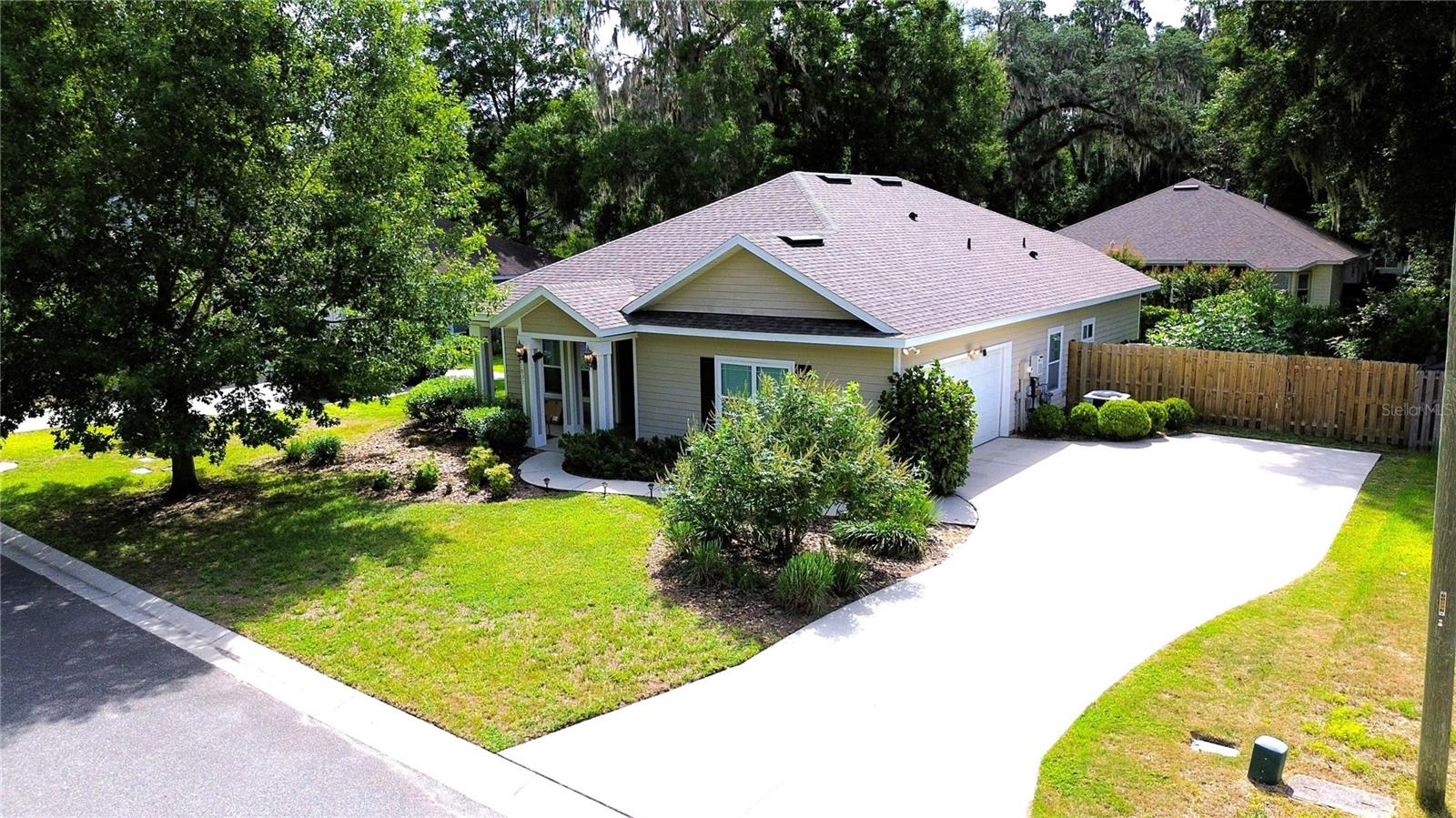 Welcome to your dream home in the highly desirable SW Gainesville area! Situated just minutes from UF, Shands, Butler Plaza, the Oaks Mall, and I-75, this location is truly hard to beat. The premier neighborhood of Portofino provides community amenities including a pool, playground, and basketball court, while zoned for A rated schools. The neighborhood is also backed by the stunning 200+ acres Split Rock Conservation Area. This immaculate 3-bedroom, 2-bathroom home is packed with high-value upgrades. Enjoy total peace of mind with a brand-new 2026 Certainteed roof featuring transferable warranty. Step inside to find an elegant interior elevated by classic crown molding and hard-surface flooring throughout the main living areas. The gourmet kitchen is a chef's delight, boasting sleek granite countertops and a suite of newer 2025 stainless steel appliances. Escape to the luxurious primary bedroom suite, featuring a striking architectural tray ceiling and an abundance of natural light. Energy efficiency is maximized with low-E vinyl windows and a tankless water heater. Outside, you will find a covered lanai and back porch, a fully fenced backyard with fruit trees, and an attached 2-car garage with a side-entry configuration and an enormous driveway.