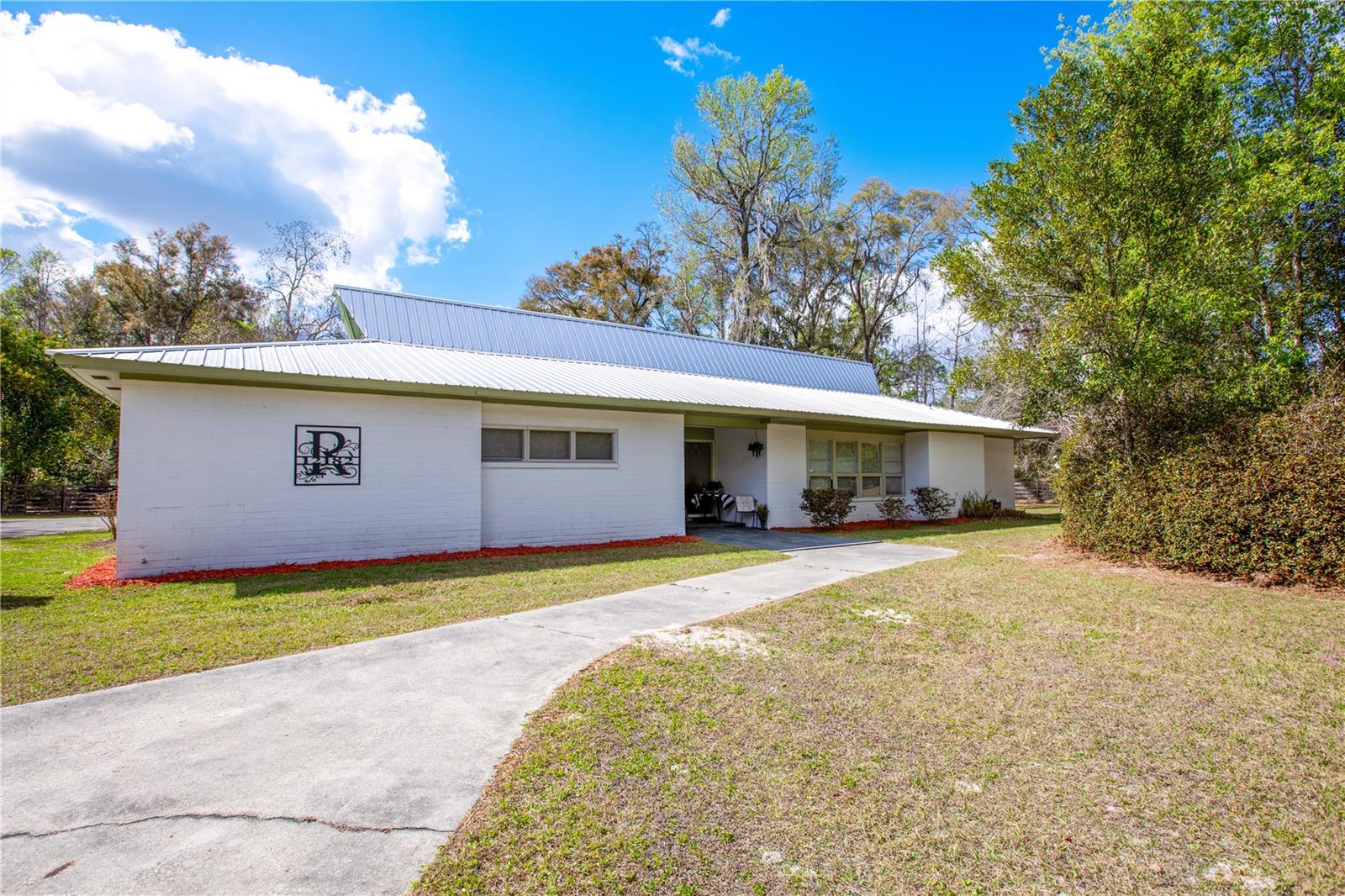 *MOTIVATED SELLERS! Bring an offer!* Uniting timeless brick craftsmanship with modern updates and peaceful outdoor living, this 3/2 + THREE bonus rooms on 1.47acres offers the secluded lifestyle you’ve been searching for! From the moment you step through the grand tiled entry and formal foyer, you’ll feel the intentional upgrades throughout. This home features a newer roof (2021), full HVAC system with ALL NEW ductwork (2023), freshly painted exterior, and a brand new water heater (2026) - giving you peace of mind for years to come. Inside, natural textures and warmth steal the show: with refinished hardwood floors, exposed brick, tailor-made book shelving, and a stunning cedar room where oversized floor-to-ceiling windows provide panoramic views of your backyard oasis, blurring the line between indoors and out. A custom-built pantry, upgraded lighting, added fixtures, oversized closets, and built-in storage elevate everyday living. Step outside to experience the ultimate lifestyle upgrade - where the cleared lot delivers vast usable space while preserving a wooded buffer from the road for ultimate privacy. A massive fenced area for fur babies to run free, stone-centered seating around a firepit, and a covered carport equipped with a luxury Bluetooth sound system create the perfect setup for entertaining or relaxed evenings. Best of all, there are so many fruit trees that you could nearly live off the land, including a huge mulberry tree, 2 pear trees, peach tree, Japanese plum tree, an orange tree, a grapefruit tree, 2 nectarine trees, and a lime tree! All of this is just 15 minutes to Celebration Pointe and Tioga Town Center - allowing you to live in quiet serenity while staying close to the city’s best dining, shopping, and vibrant atmosphere. It’s such a rarity for a property with this acreage, upgrades, and intention in one complete package to come on the market. *BONUS - C2 zoning allows for abundant business opportunities while being able to live on site! *A clear 4-point is readily available to assist you with a low-cost insurance rate. Call today to schedule your showing!