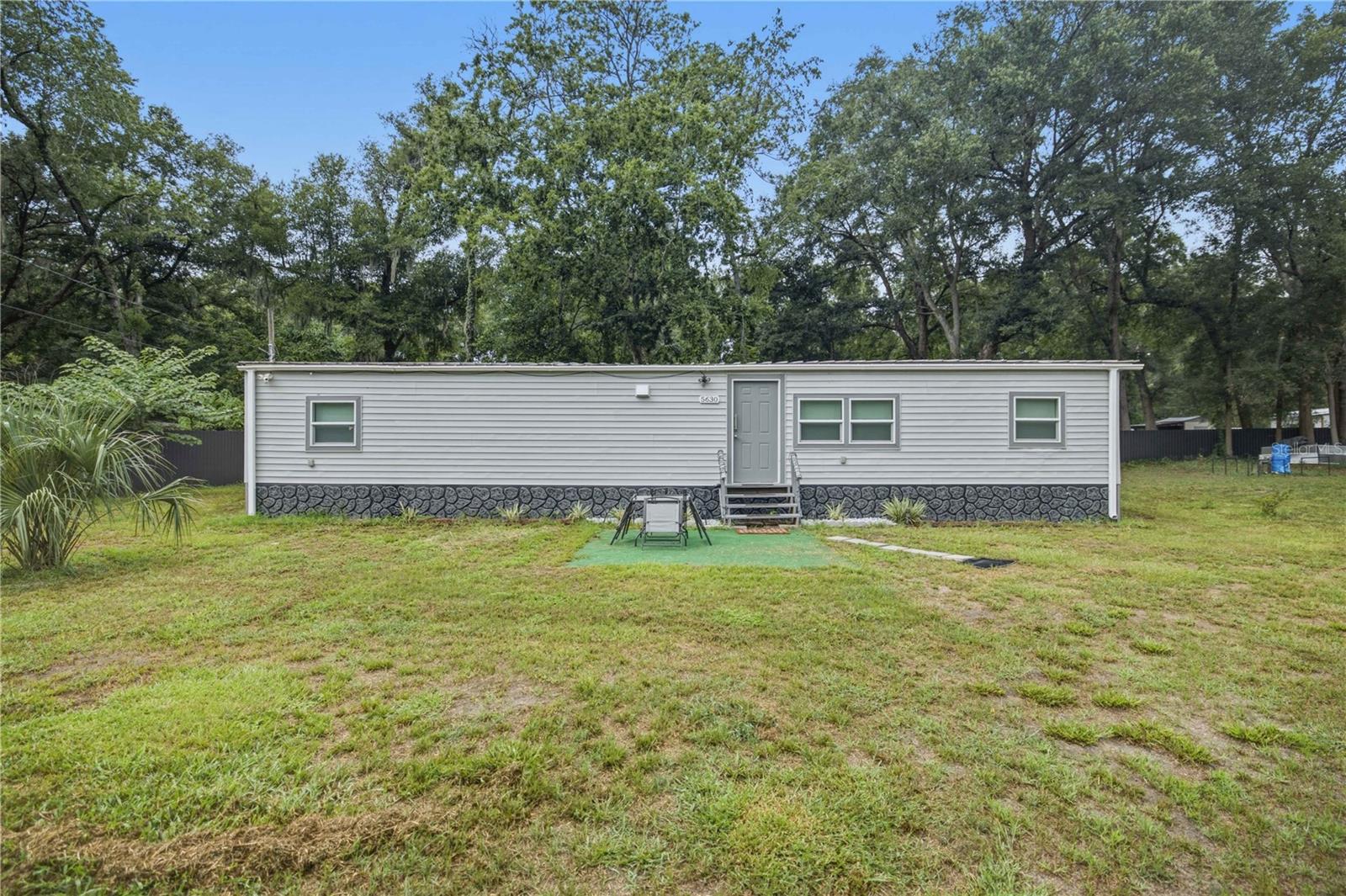 Welcome home to this beautifully renovated 2-bedroom, 2-bath mobile home that perfectly combines modern style with everyday comfort. Situated on a spacious 0.66-acre lot, this property offers an oversized yard with endless possibilities for entertaining, gardening, pets, or simply enjoying the outdoors.

Step inside to an inviting open-concept floor plan featuring durable luxury vinyl flooring throughout. The updated kitchen is complete with granite countertops, stainless steel appliances, and plenty of cabinet space, creating a stylish and functional space for everyday living.

The thoughtfully designed split-bedroom floor plan places each bedroom on opposite sides of the home, offering added privacy for owners and guests alike. The primary bedroom features its own private en-suite bathroom, while the second bedroom is located next to the home's second full bathroom.

Conveniently located in the heart of Ocala, this home is just minutes from shopping, dining, medical facilities, and everyday conveniences while still offering the space and privacy of a large 0.66-acre lot. Move-in ready with modern updates and an unbeatable combination of style, functionality, and location, this home is ready for its next owner.