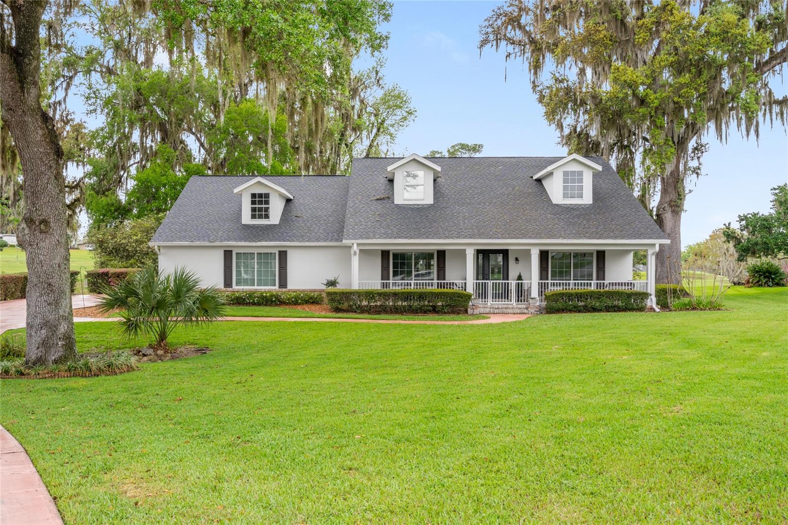 Back on the market with a brand-new drain field, this beautifully remodeled 3-bedroom, 2.5-bath home adds yet another major improvement to its already extensive list of upgrades. Located in the highly sought-after Golden Hills community and perfectly positioned on a quiet cul-de-sac, this charming residence enjoys peaceful views overlooking the newly improved Ocala National Golf Course.

A welcoming, expansive front porch sets the tone for the home, offering the perfect shaded spot to enjoy your morning coffee while taking in Florida’s beautiful weather. Inside, the home greets you with soaring ceilings, luxury vinyl plank flooring, and stylish finishes throughout, creating a bright and inviting atmosphere from the moment you enter.

The light-filled living room is positioned at the front of the home and flows effortlessly into the main living areas. At the heart of the home is the beautifully updated kitchen, featuring quartzite countertops, solid wood cabinetry, stainless steel appliances, a wine refrigerator, and a large island with seating, perfect for entertaining or everyday living. The kitchen overlooks the spacious family room, creating an open and functional gathering space.

Just beyond, the dining area is bathed in natural light and offers lovely views of the golf course, with direct access to the expansive screened porch, an ideal setting to relax and enjoy the tranquil surroundings.

The primary suite provides a peaceful retreat with a generous walk-in closet and a beautifully designed ensuite bathroom featuring dual vanities, a classic clawfoot soaking tub, a large tiled walk-in shower, and a picture-style frosted window that fills the space with natural light while maintaining privacy.

The guest bedrooms are comfortably sized and share a well-appointed bathroom with a spacious walk-in shower, stone-topped vanity, and charming shiplap accent wall.

A large laundry room, which also serves as a convenient half bath, is ideal for guests. In the oversized garage, you will find an additional washer and dryer, perfect for equestrian enthusiasts or for separating outdoor gear and barn wear.

Outdoor living continues on the screened porch overlooking the golf course, offering ample space to relax or entertain. Just beyond, a stone patio provides the perfect setting for gatherings, grilling, or enjoying the peaceful backyard setting.

Ideally located just minutes from the World Equestrian Center, as well as shopping, dining, and everyday conveniences, this property offers exceptional versatility. Whether you are looking to establish permanent roots, enjoy a seasonal retreat, or invest in a desirable long- or short-term rental, this beautifully updated home is perfectly positioned to meet your needs.

Don’t miss the opportunity to own this move-in-ready gem in one of Ocala’s most desirable communities.