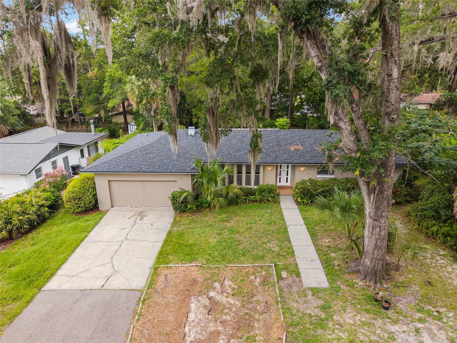 Spacious NW home in one of Gainesville’s most coveted neighborhoods near the University of Florida. This solid concrete-block residence offers nearly 2,000 square feet of living space with 4 bedrooms and 2 full bathrooms, plus a large 2-car garage. The interior was recently repainted, the roof is newer (2023), and both bathrooms were just updated in 2026, giving the home a fresh, move-in-ready feel. Inside, you’ll find an expansive living room, a separate dining room, and family room adjacent to a generous U-shaped kitchen with countertop bar. The primary bedroom is impressively sized (nearly 14' x 14') and features its own private ensuite bathroom and 'his & hers' walk-in closets. One of the noteworthy features of this layout is the fourth bedroom positioned on the opposite side of the home, creating an ideal guest suite or dedicated home office with convenient access from the garage. The home also boasts an incredible oversized screened-in lanai which is an entertainer’s dream and the perfect extension of the living space. Situated on a wooded, private lot near the end of a cul-de-sac, the setting is both charming and tranquil. The location is unbeatable: just 1.5 miles from the University of Florida, and steps from Littlewood Elementary, Westside Pool/Albert Massey Park, and Loblolly Nature Park. It’s also centrally located, offering a quick drive in any direction to everything Gainesville has to offer. The home is zoned for some of the area’s premier schools. This is a rare opportunity to own a spacious, move-in-ready home on a quiet dead-end street with thoughtful upgrades in one of Gainesville’s most desirable neighborhoods.