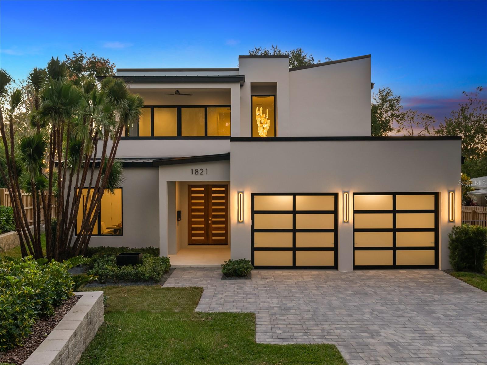 This stunning new contemporary residence, a five-bedroom, five-and-a-half bath home by the renowned Rex-Tibbs Development, a custom builder for over 40 years, continues to set the standard for luxury living. Perfectly situated on a premium, quiet, charming brick street, the home blends clean architectural lines with timeless finishes and thoughtful design details. An elegant foyer immediately introduces the home’s refined aesthetic, offering a direct line of sight to the gorgeous herringbone white oak floors in the great room and the sparkling pool just beyond the full glass doors. Anchored by a sleek linear gas fireplace with custom built-ins and floating shelves, the great room provides an inviting yet sophisticated gathering space. The open-concept chef’s kitchen is a showpiece in both form and function. Outfitted with Wolf and Sub-Zero appliances, it boasts an eight-burner range with one-and-a-half ovens, an oversized Sub-Zero French door refrigerator with a freezer drawer, a built-in microwave drawer, and a walk-in pantry featuring a wine and beverage tower. Marble counters in all baths continue the home’s commitment to refined finishes. The main level primary suite is a serene retreat with a spa-inspired bath featuring a large glass-enclosed shower, separate soaking tub framed by dramatic four-by-ten-foot porcelain slabs, a custom walk-in closet, and a private water closet. A flexible fifth bedroom with an ensuite bath offers the perfect option for an office or den. A striking glass-railed staircase leads to the second level, where a spacious lounge area opens to a private covered patio. Three additional ensuite bedrooms, each with custom closet systems, complete the upstairs living quarters. Designed for indoor-outdoor living, the expansive covered lanai includes a summer kitchen with a grill, hood vent, refrigerator, sink, and a dedicated half bath. Overlooking lush landscaping with tropical Clusia hedges and Foxtail palms, the brand-new pool is finished with designer tile that lends a stylish, resort-quality flair. Additional highlights include a spacious storage closet under the staircase, oversized two-car garage, 500-gallon propane tank for easy generator connection, stone paver driveway and durable metal roof. Wonderfully located in a picturesque neighborhood, the property is just minutes from the boutiques and dining of Park Avenue, top-rated public and private schools and offers convenient access to downtown Orlando, the attractions, as well as area airports. A rare opportunity to own a newly constructed home of such quality and craftsmanship in one of Winter Park’s most sought-after neighborhoods.