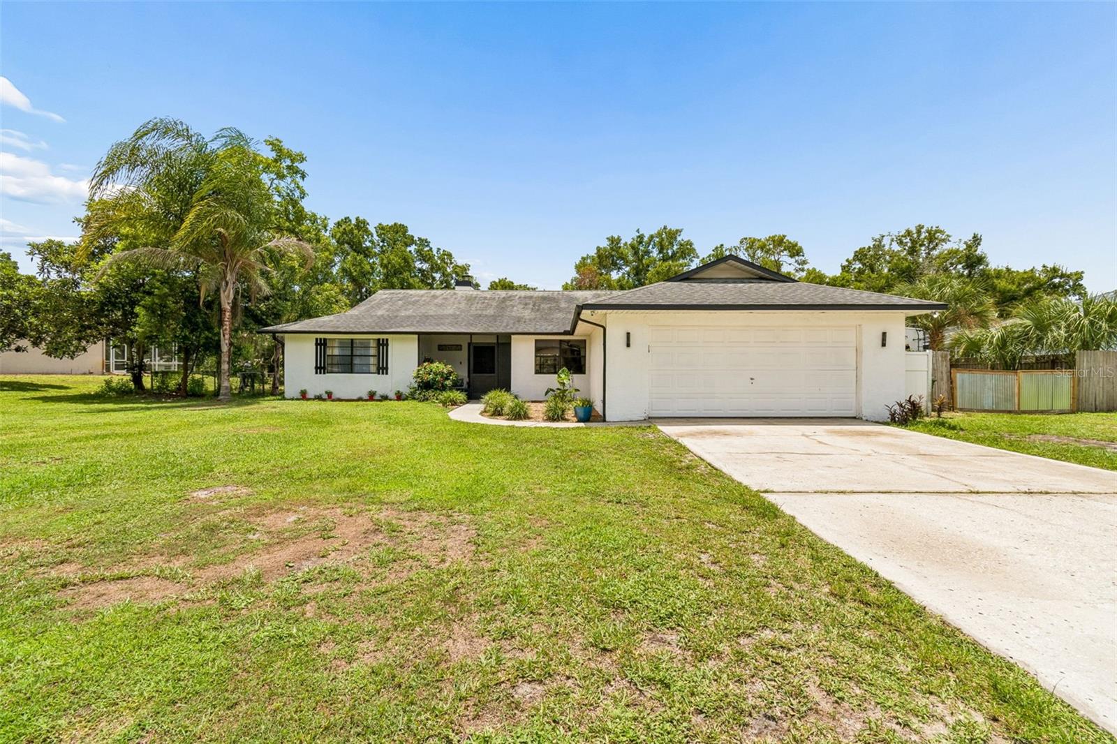 Move-in ready with no HOA, single-level living, and affordable ski lake access, this beautifully updated 4-bedroom, 2-bath home offers 1,912 SqFt on an oversized canal-front homesite leading to 88-acre ski-sized East Lake in the highly sought-after Lake Padgett Estates. The spacious homesite offers plenty of room to park your RV, boat, trailer, and other recreational vehicles. Recent updates include new luxury vinyl plank flooring, interior paint, interior doors, light fixtures, and ceiling fans (July 2026), A/C (2023), and well pump (2025). Double front doors welcome you into a bright, open layout filled with natural light, featuring a spacious great room with a wood-burning fireplace and pocket sliding glass doors that open to the large covered lanai with dual ceiling fans overlooking the canal. The kitchen overlooks the living area and features granite countertops, stainless steel appliances, a large center island, ample cabinetry, and generous counter space. The split-bedroom floor plan provides privacy for the primary suite, while a formal dining room offers additional entertaining space. The laundry room includes built-in cabinetry, a utility/storage closet, and a utility sink hookup. A water softener adds to the home's everyday convenience. Lake Padgett Estates offers access to three ski-sized lakes, horse stables, parks, and recreational amenities. Location is everything—zoned for top-rated Sunlake High School and just minutes from Publix, Target, Walmart, Costco, Tampa Premium Outlets, restaurants, dining, entertainment, and convenient access to I-275. You'll also enjoy being approximately 30 minutes from Tampa International Airport, Downtown Tampa, and the University of South Florida (USF). Enjoy the perfect blend of lake living, everyday convenience, and the freedom of no HOA. Don't miss your chance to own this rare opportunity for affordable ski lake access in one of Land O' Lakes' most desirable communities!