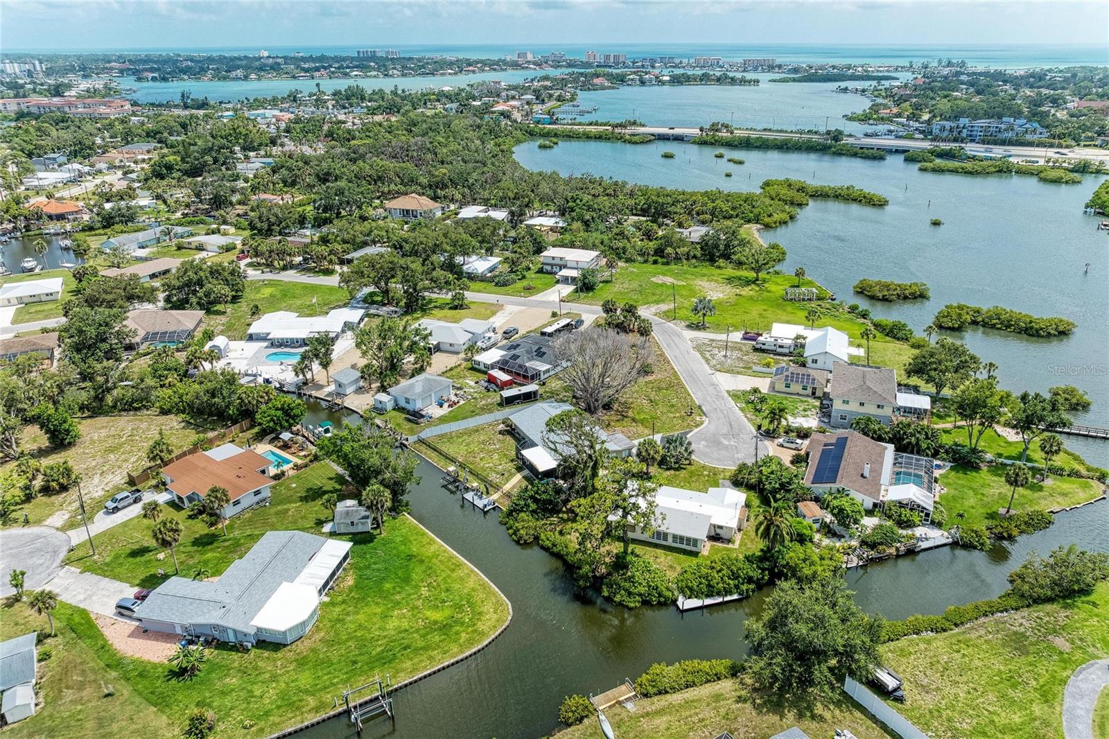 Waterfront living, a private boat lift, dock, and direct access to Dona Bay and the Intracoastal Waterway make 302 Dona Drive an exceptional opportunity to embrace the Florida lifestyle. Tucked away on a quiet cul-de-sac in Nokomis Acres, this canal-front property offers more than 100 feet of waterfront frontage, giving you the freedom to launch your boat from your backyard, spend the day on the water, relax at Nokomis or Venice Beach, and return home in time to unwind as the sun sets over the canal. Inside, the home has been thoughtfully updated while preserving the timeless character that makes waterfront Florida homes so desirable. Terrazzo floors run throughout the open-concept living spaces, including a renovated kitchen, bringing everyone together after a day on the water. Expansive windows fill the home with natural light and create a seamless connection between the indoor living areas and the waterfront setting. The spacious primary suite offers a peaceful retreat with an en-suite bath and generous closet space. A second bedroom, three full bathrooms, and flexible bonus space provide endless possibilities for guests, a home office, hobbies, or future customization. Step outside and discover what truly sets this home apart. The expansive screened lanai serves as an outdoor living room, creating the perfect place for entertaining, dining, or simply enjoying Florida's year-round indoor-outdoor lifestyle. Beyond the lanai, the oversized backyard offers plenty of room to add a pool while still leaving space for pets, gardening, or outdoor recreation. Located just minutes from Nokomis Beach, Venice Beach, the Legacy Trail, waterfront restaurants, marinas, shopping, and Historic Downtown Venice, this home combines boating, beaches, and everyday convenience in one of Nokomis' most desirable waterfront neighborhoods. With more than 100 feet of canal frontage, a private boat lift and dock, no HOA, and convenient access to Dona Bay and the Intracoastal Waterway, this is a rare opportunity to own a move-in ready waterfront home at a price point that is becoming increasingly difficult to find.