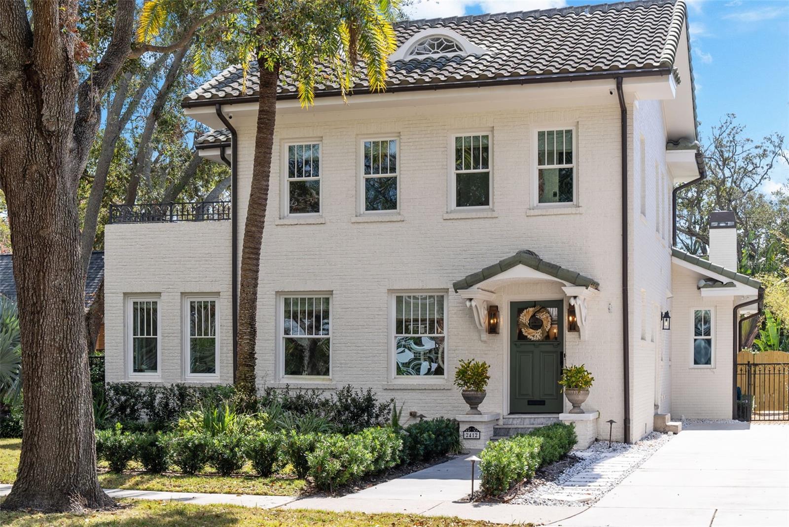 Perfectly positioned on one of the prettiest streets in Tampa awaits your new home. This stunningly updated beauty is like no other.  As you approach the three-story brick masterpiece, look around at the street replete with a gorgeous canopy of trees creating an idyllic setting.  Note the sidewalks for evening strolls and expansive front yards for extended play.  Step inside the front door to note the rare combination of historic charm with modern finishes.  There is exceptional millwork, wide plank oak floors, high ceilings and beautiful light fixtures creating an impressive setting.  To your right, travel up a flight of stairs to three secondary bedrooms and two full baths.   You will also find. 3rd floor bonus nook.  It’s the perfect spot for watching movies, curling up with a good book or playing games.  Back on the first level, the foyer opens to a formal living space with decorative fireplace.  Walk through the brick lined archway to the sun porch, the perfect space for an office.  Another brick lined archway leads to your formal dining room.  The kitchen is a chef’s dream!  The focal point is a gorgeous La Cornue gas range but there is so much more to appreciate!  The oversized island with storage and marble counters are the perfect spot for informal meals.  All the cabinets are handcrafted and designed specifically for the home.  The marble counters continue to a partial backsplash which meets a beautiful ceramic subway tile leading to the ceiling.   There is a hidden working pantry and more storage under the stairs.  For those who love to entertain, there is a stunning wet bar with marble counters, antique glass backsplash, a built in Miele coffee maker, an ice maker and beverage fridge (all behind cabinet panels for a seamless sightline).  The kitchen opens to an oversized family room with a cathedral ceiling.  Want to take the party outside?  Open your wall of sliders and step onto your screened lanai.  There are brick pavers, plenty of space to relax and a wood burning fireplace for cool evenings.  When it’s warm, enjoy a dip in your saltwater pool or soak in the spa.  It is all possible here!  Back inside, retreat to the primary suite with stunning ceiling millwork and light fixture.  It is a great escape!  There are two walk-in closets and ample space for furniture.  The bathroom offers beautiful marble tile, separate vanities, tall cabinets, a vintage claw foot tub and walk in shower.  Beyond the primary, there is a large laundry room with marble counters and custom cabinets.  There is also a beautiful powder bath with close entry from the pool.  The drop zone by the two-car garage is enviable with 4 cabinets and deep drawers for shoes.   Up the back staircase, find a guest retreat.  There are two rooms, each with closets (for a 5th and 6th bedroom if needed), a full bath and wet bar.  Other features include a long drive way for additional parking in the front and an automatic gate off the back for garage entry.  Zoned for A rated schools (Mitchell, Wilson and Plant), close to downtown Tampa, and Tampa International Airport.  Schedule your showing today!