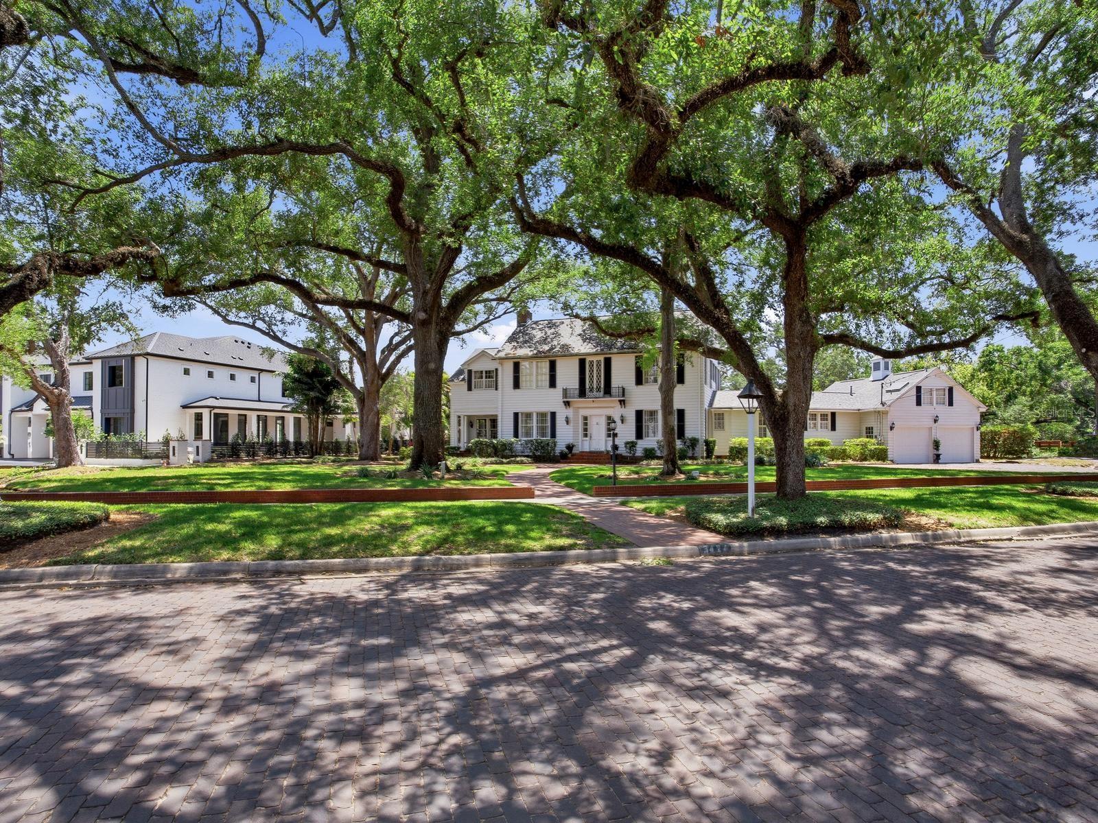 Set along the prestigious Palma Ceia Golf Course in South Tampa, this exceptional Colonial estate rests on an expansive, two lot, park-like parcel exceeding 30,000 square feet with 166’ of golf course frontage. Framed by mature trees and lush, curated landscaping, the residence enjoys a picturesque setting along a charming brick-lined street, adjacent to a serene side park.
Inside, the home reveals a masterful blend of timeless sophistication and inviting comfort. Offering four elegant bedrooms, two smaller private offices, a sunlit garden room, and refined formal living and dining spaces, every corner is designed for both grand entertaining and intimate living. A distinguished sitting room, or library, and powder room add to the home’s classic appeal, while the well-appointed kitchen flows seamlessly into a warm family gathering area overlooking the sweeping golf course vistas and expansive grounds beyond. The third office is a major room off the living room that overlooks the golf course and private terrace. 
A dramatic sweeping staircase, accented by dual landings, leads to three beautifully proportioned bedrooms, a shared bath, and a tranquil sitting area within the primary suite. The primary retreat is further enhanced by an extraordinary, room-sized dressing closets for his and hers. A secondary staircase offers a private ascent to the fourth bedroom suite, distinguished by its unique architectural ceilings and charming character and cathedral ceiling sitting area overlooking the golf course.
Throughout the home, each room is meticulously curated with period antiques and collectible details, evoking the ambiance of a refined gallery while maintaining a light-filled, airy atmosphere. Outdoors, an expansive patio and elegant pavilion provide a stunning setting for entertaining, all against the breathtaking backdrop of the golf course.
A rare offering, this residence embodies classic Old World elegance with a relaxed yet sophisticated sensibility—truly one of a kind. Located in the heart of South Tampa, Tampa International Airport, Midtown, premier shopping, major malls, and top-rated schools are all within proximity. Gulf beaches and local theme parks, Busch Gardens and Zoo Tampa are approximately 20 minutes away and only an hour and a half to Disney.