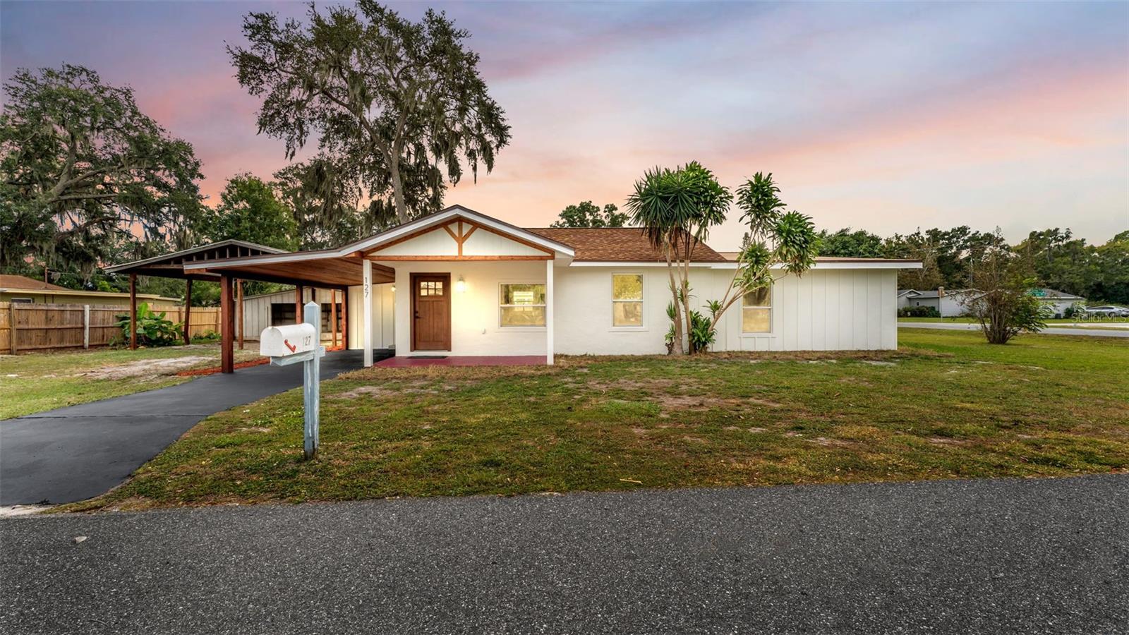 Discover the perfect blend of charm, character, and modern upgrades in this beautifully renovated 3-bedroom, 2-bath home located in a desirable Auburndale neighborhood close to shopping, dining, schools, and everyday conveniences. Nearly every inch of this home has been updated, including all-new wiring, wall insulation, roof, windows, interior and exterior doors, lighting, fans, exhaust fans, fire alarm system, and fresh interior and exterior paint. Inside, you'll love the stunning natural white wood shiplap accents, crown molding, decorative trim work, and beautiful Tidal wood tongue-and-groove ceilings that create a warm and inviting atmosphere. The updated kitchen features custom cabinetry, a farmhouse sink, elegant faucet, and a stylish range hood, while the guest bathroom has been completely remodeled. New luxury vinyl flooring and carpet flow throughout the home, providing a fresh, move-in-ready feel. Situated on a spacious corner lot, there's plenty of room for entertaining, gardening, or future additions. An open barn offers excellent storage or workshop space, and the screened porch provides the perfect spot to enjoy Florida living while taking advantage of the convenient washer and dryer area. This one-of-a-kind property combines timeless character with extensive modern updates and is ready for its next owner to call home.