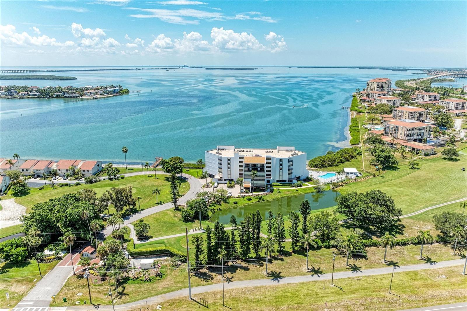 MOTIVATED SELLER !!!! This is the one you’ve been waiting for. LOCATION, LOCATION, is everything—so stop shoveling snow and start shoveling sunshine at your own private waterfront retreat in Vista de Oro at Playa Escondida. This is coastal living at its finest—an offering as rare as it is remarkable.

Spanning more than 1,300 square feet, this exquisitely FURNISHED & TURNKEY, 2 bedroom, 2 bath residence is bathed in natural light and showcases sweeping panoramas of Tampa Bay, Boca Ciega Bay, and the iconic Skyway Bridge from the views outside. The serene waterfront setting evokes the ambiance of a private resort, delivering tranquility and refined sophistication year-round.

Inside, a thoughtful blend of tile and carpet flooring, elegant crown molding, and expansive windows creates a space that feels both polished and inviting. Newer A/C, renovated kitchen & bathrooms provide modern efficiency, comfort, and peace of mind.

Designed for effortless entertaining and everyday enjoyment, the open-concept living and dining areas flow seamlessly onto a stunning  balcony. Accessible from the main living spaces and all bedrooms, this extraordinary outdoor retreat captures breathtaking of the beautiful golf course. Perfect for quiet mornings, golden sunsets, and elegant evenings beneath the sky.  Private balcony overlooking the lush golf course and shimmering bay beyond.

The thoughtfully designed split-bedroom layout offers exceptional privacy. The primary suite is a true sanctuary, featuring a generously sized walk-in closet, dual vanities, an expansive walk-in shower. . The secondary suite includes a spacious closet, a full bath, and a beautiful view. 

Additional highlights include an in-unit laundry room, assigned covered parking beneath the building, and ample guest parking. Residents enjoy access to a newly updated waterfront pool and spa, a gazebo, a fitness center.

Optional membership to the Isla del Sol Yacht & Country Club opens the door to championship golf, boating, fine dining, and a vibrant social calendar. Ideally located just minutes from downtown St. Petersburg, a short drive to Tampa International Airport, and moments from world-renowned white-sand beaches, this residence offers the perfect balance of seclusion and convenience.

Move-in ready and truly one of a kind, this exceptional home delivers incomparable views, refined craftsmanship, and timeless coastal elegance. Arrange your private showing today and experience this rare offering in all its splendor.