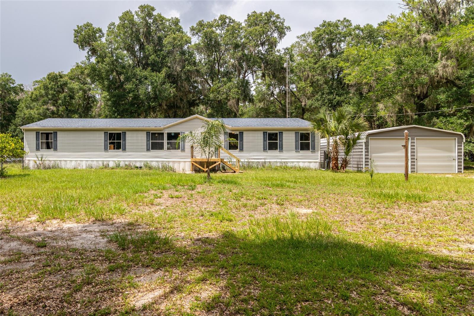 Escape the hustle and enjoy the freedom of country living on 3.31 fully fenced agricultural acres! This well-maintained 4-bedroom, 2-bath home offers over 2,100 sq. ft. of comfortable living space with plenty of room to spread out, both inside and out. Major updates include a NEW HVAC system and NEW Generac whole-home generator, providing comfort and peace of mind year-round. A detached 2-car garage/workshop offers endless possibilities for vehicles, storage, projects, or equipment. Bring your animals, start a garden, or simply enjoy the privacy and open space this versatile property provides. Ideally located between Ocala and Gainesville with convenient access to I-75, shopping, dining, medical facilities, the World Equestrian Center, and outdoor recreation. Whether you're a first-time homebuyer dreaming of acreage, looking to downsize without sacrificing space, or an investor seeking a property with strong rental appeal and agricultural zoning, this home offers exceptional value and endless potential. Don't miss your opportunity to own your own piece of Florida countryside!
