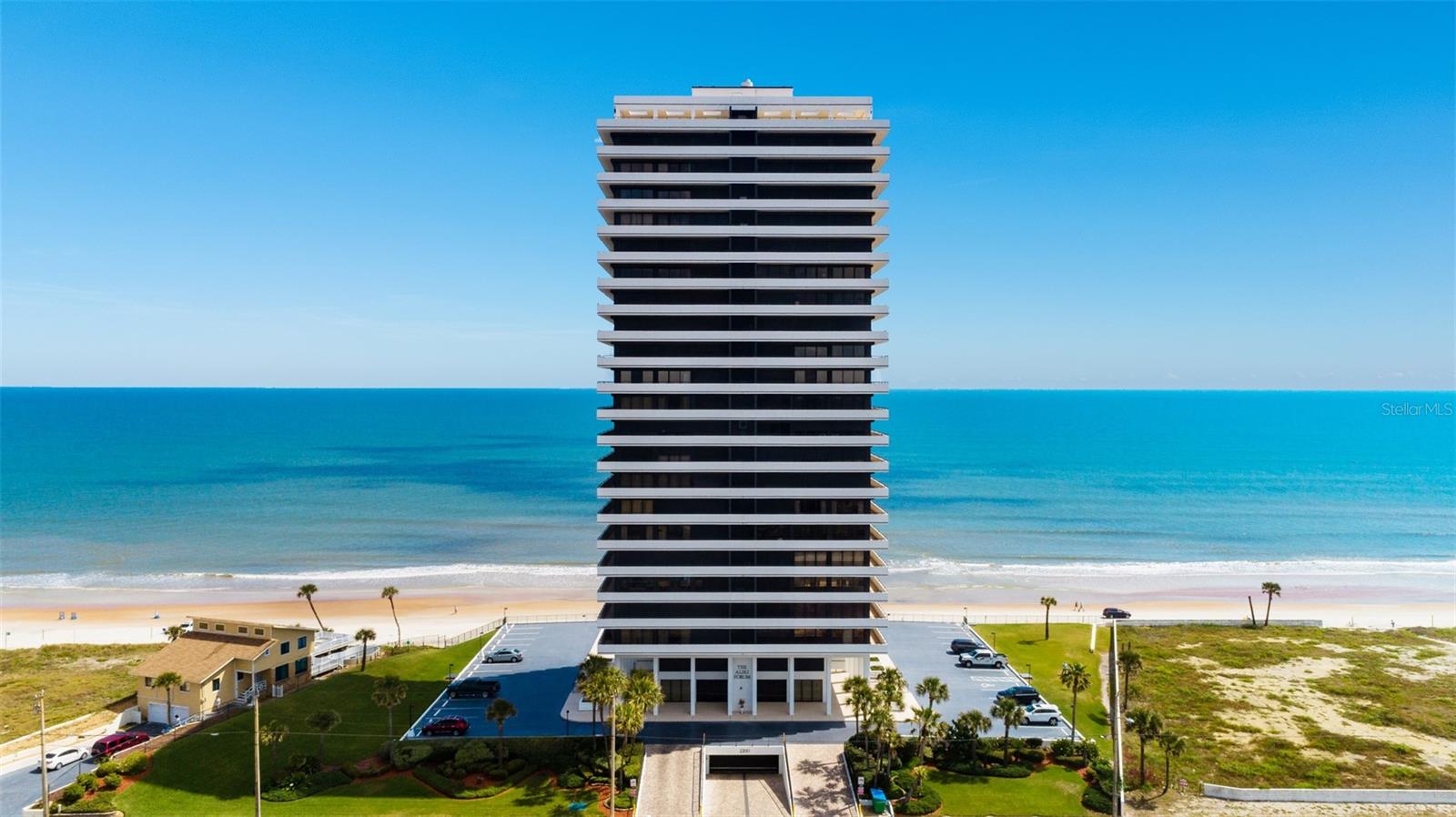 Experience coastal living at its finest in this beautifully updated oceanfront residence offering two bedrooms, two bathrooms, and an expansive open den that can easily be transformed into a third bedroom, home office, or additional guest retreat. Designed to capture the beauty of the Atlantic from every angle, this exceptional home features breathtaking panoramic views and an extraordinary 180-degree wraparound balcony where sunrises, sea breezes, and endless shoreline vistas become part of everyday life.

Inside, the thoughtfully renovated interior blends comfort and style with updated flooring, fresh paint, a modernized kitchen, and an open-concept layout ideal for both entertaining and relaxed beachfront living. Floor-to-ceiling glass fills the living spaces with natural light while showcasing spectacular ocean views from nearly every room. For added peace of mind, electric hurricane shutters provide convenient storm protection, allowing you to secure your coastal retreat with ease.

Residents enjoy the privacy and exclusivity of a boutique oceanfront community offering direct beach access, a refreshing oceanfront pool, outdoor grilling area, fitness center with sauna, outdoor shower, additional private storage, and ample guest parking on the upper deck. One assigned underground parking space is included, with a second underground parking space available for purchase.

Whether you are searching for a primary residence, seasonal getaway, or investment opportunity, this move-in-ready condominium presents a rare chance to own a beautifully updated oceanfront home in one of Daytona Beach's most desirable coastal settings.