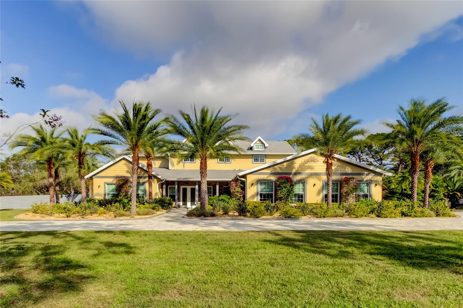 This exceptional 6,727 sq ft executive estate offers an unparalleled blend of luxury, comfort, and modern sophistication. Nestled in the heart of Pinellas, this hidden gem community boasts approximately 70 estate-style properties, each set on expansive 2+ acre lots, providing privacy and tranquility in a non-flood zone setting.
Built in 2022, this custom home showcases an open-concept design, perfect for both large scale entertaining and everyday elegance. At the heart of the home lies a gourmet kitchen, centered around the 22-foot island, offering ample space for culinary creations and casual gatherings alike. The expansive living room accommodates an oversized sitting area and a baby grand piano, while overlooking the sparkling pool and serene backyard oasis. The formal dining area comfortably seats 12 — ideal for hosting unforgettable events.
Step outside into your private retreat, featuring a ~30,000-gallon solar-heated saltwater pool and spa. An outdoor kitchen invites you to enjoy al fresco dining, while generous lounging areas provide the perfect backdrop for relaxation and entertaining.
The luxurious ground-floor primary suite is a haven of comfort, complete with dual walk-in closets, spa-inspired bath, split vanities, and a rain shower. Also on the main level is an oversized fitness room with an adjacent bath, offering the flexibility to serve as a second primary suite or in-law quarters. Additional ground-floor amenities include an oversized executive home office, two guest bedrooms, and a full bath.
Upstairs, the 1,761 sq ft second level offers a thoughtfully designed layout with three bedrooms, 2 full baths, a bonus room, and a study.
Crafted with the finest materials and top-tier appliances, this home also boasts hurricane-impact windows, a whole-house generator, zero-entry showers and doors, and a state-of-the-art security system — delivering both luxury and peace of mind.
This estate embodies the perfect balance of elegance, functionality, and serenity. Don't miss your chance to own this one-of-a-kind property in a premier location. Schedule your private tour today and step into the extraordinary.  Sellers open to lease purchase.