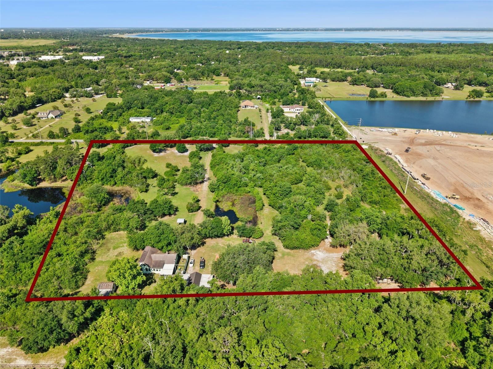 SAME DAY SHOWINGS AVAILABLE! Rare acreage opportunity in one of St. Cloud’s fastest-growing corridors! Whether you are a builder, developer, investor, or buyer seeking land near Center Lake Ranch, Lake Nona, Narcoossee, and major Central Florida growth areas, this approximately 9.97-acre property offers exceptional potential. Features include well water, septic, paved road frontage, mature trees, open land, surface water areas, and multiple storage/outbuilding improvements. Environmental due diligence has been completed, with the November 2025 survey available in the attachments. An existing 4-bedroom, 2-bath single-family residence offers 1,592 heated square feet; however, buyers should be aware that the primary value is in the land rather than the home itself. Whether held for future use, improved, or evaluated for development potential, this property offers strong acreage value in one of Osceola County’s most active growth corridors. Schedule your same-day showing today!