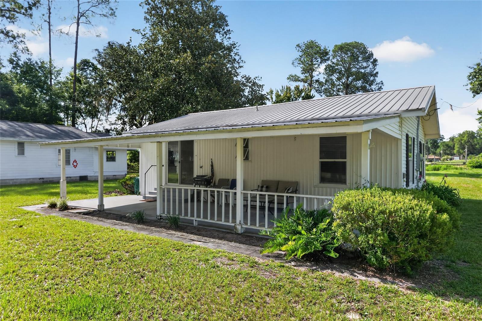 Are you looking for a cute and cozy lakefront cottage? This may be the perfect home for you! This 2 bedroom, 1 bathroom house sits on a grassy and scenic 0.67 acre lot on beautiful Grandin Lake. This large clear water lake is great for fishing, boating, tubing, kayaking, and paddleboarding. You will love spending time on the water and relaxing at the lake. This 1964 cottage features a screened-in back patio as well as an open front porch which can be used as a 1 car carport. There is also an outbuilding which houses the laundry hookups, well equipment, and extra space for storage. Inside, you will find two spacious bedrooms, large living room, and a practical layout. The home has been well maintained, and notable recent upgrades include a new septic tank and drainfield installed in 2022, as well as new electrical panels installed in 2023. This home also has a durable metal roof. The neighborhood offers a private boat ramp, and a private swim area for resident's use, as well as a clubhouse which can be rented for events. This would be an ideal primary residence, weekend home, or you could even use it as a vacation rental. This property is priced below a recent appraisal, so that you can make it your own and have instant equity! Call your agent for a showing of this adorable lakefront home!