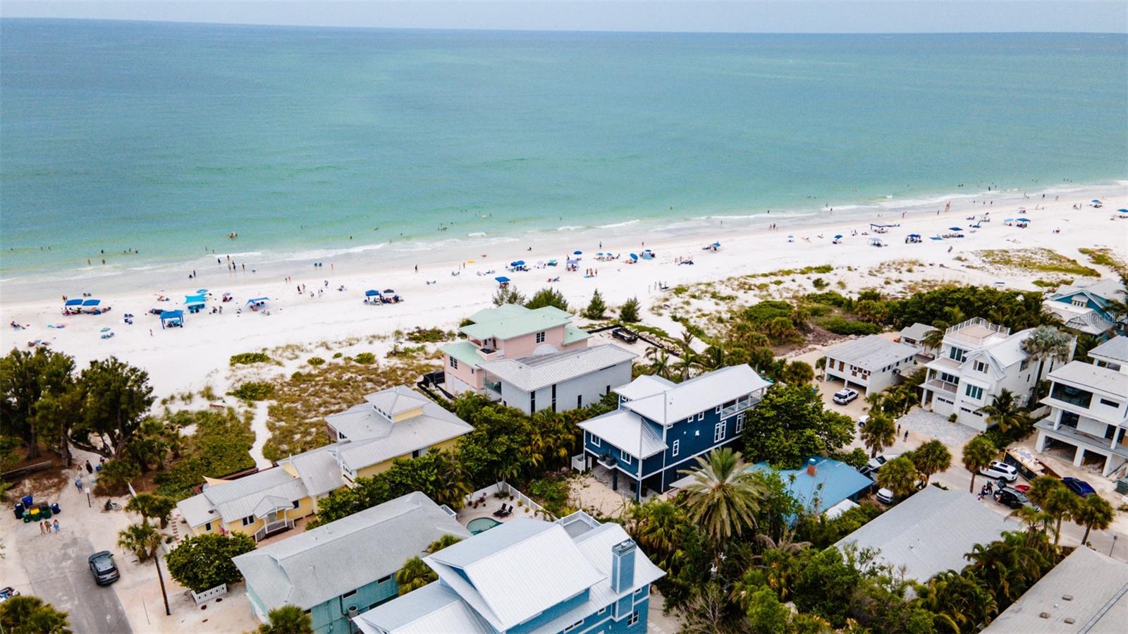Beachfront Oasis is elegant European design luxury home that has been professionally decorated and has spectacular  beach views from every room. Floor to ceiling glass allows full views of the beach and aqua tropical gulf waters. The clean lines of the homes upscale design allow you to just sit back, relax and enjoy the stunning open beach view on any of the four beachfront decks. Indulge in the home’s high-end finishes from the moment you walk in the door including a private elevator to all floors. Once you’re on the main level you’re welcomed by breathtaking views, the high-end kitchen and open concept living and dining areas that are perfect for entertaining. The high-end kitchen offers stainless steel appliances, induction stove top and built-in oven. The kitchen island provides the perfect spot for entertaining as you prepare a gourmet meal or simple treats. On the top level there are two separate master suites, both with king beds, their own private baths and private beach front balconies. On the main level, off the living room, is another bedroom with a queen bed and another private balcony. The outdoor area features a private pool and beach area with outdoor lounge chairs plus a table and chairs to enjoy poolside refreshments. Beachfront Oasis is ideally located on the quiet north-end of Anna Maria Island. It is one block from the charming Pine Ave shops, restaurants and attractions. On the bayside of Pine Ave is the Anna Maria City Pier and Waterfront Restaurant.