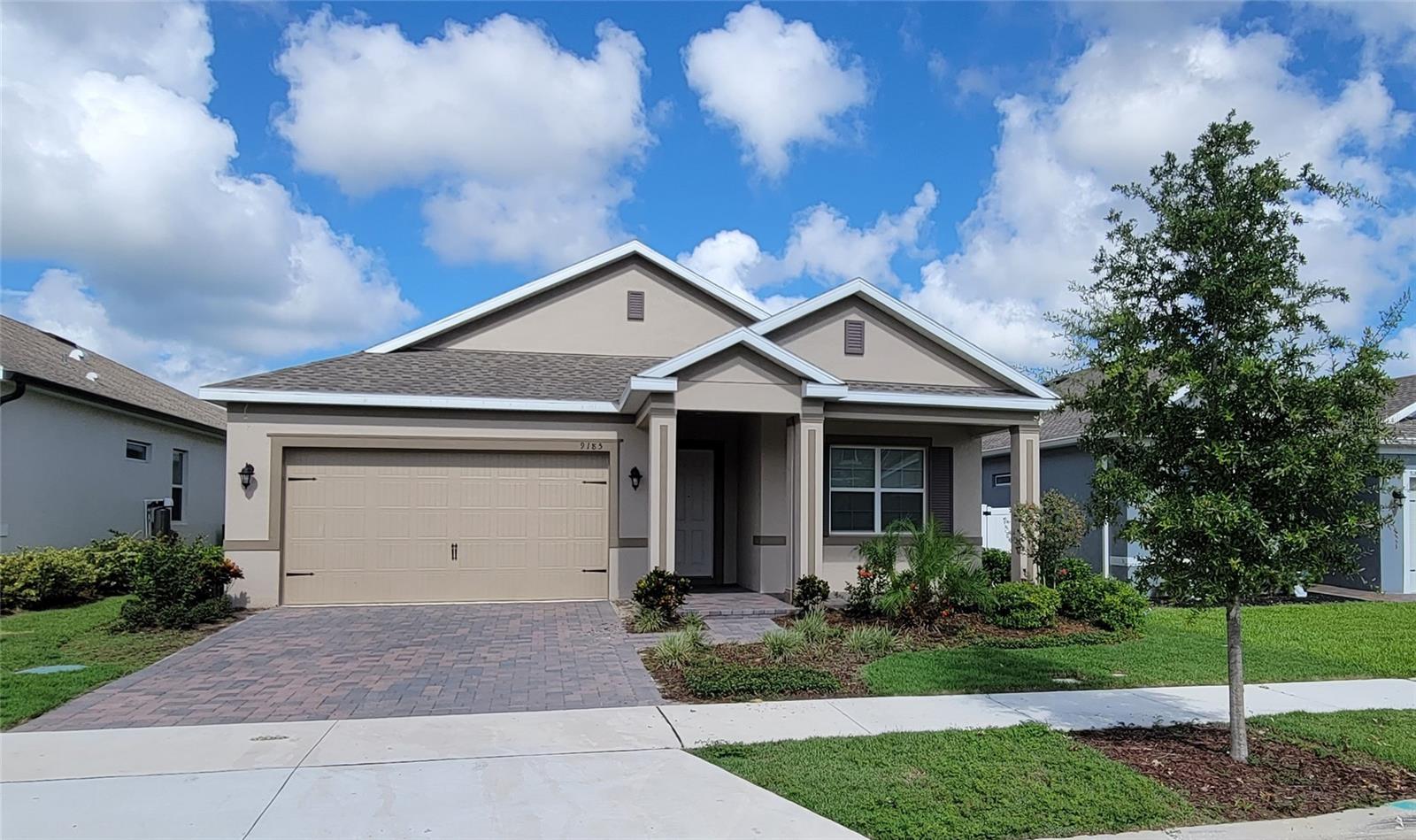 This home is a 4-3 all one floor with backyard connecting to a walk path around a dried retention pond.
Nice views of the path from the large covered lanai and the HUGE great room. The great room is open-concept with large living area, dining, and Kitchen all with 18 x 18 neutral gray tile, easy to maintain. The kitchen has nice white cabinetry with crown molding accented by Brazilian white granite and Stainless steel appliances. Large walk in pantry and Island with sink and breakfast bar, perfect for indoor and outdoor entertaining. Wide walk-in entry with 2 bedrooms sharing a bath, the third bedroom has its own private bath. The master bedroom 16x18, and great sized bathroom with walk in closets, separate toilet room, double sink vanity, lots of cabinets space, and a walk in shower with sitting bench next to the separate garden tub. An actual laundry room and small flex room of the kitchen ideal for lots of closet space in addition to the drop room off the garage to help keep your home organized and clean. All 10 foot ceilings for a more spacious feel. Magnolia at Westside is a great community with playground and very nice pool, oversized Cabana, Tot Lot, and Picnic Area, Dog park, large fields for all play and a playground. Easy access
to shopping and Posner park is a few miles down. Other stores, restaurants, entertainment, and theme parks all nearby. All information deemed
reliable but not guaranteed. Please EMAIL for more info. Renters insurance is required. Zoned for CELEBRATION HS. Located 27 and 192.
