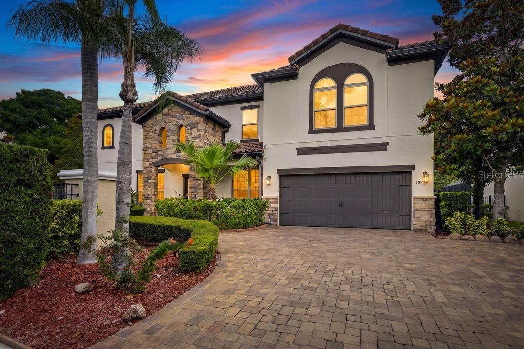 You can buy a house or you can build a legacy. Welcome to 1823 Bella Casa, a Mediterranean-inspired estate and former model home located in an exclusive gated community in the Lake Magdalene area of Tampa. Listings in this boutique enclave are few and far between. Perhaps this is the dream home you've been waiting for. 
Outfitted with every upgrade imaginable, this 4 bedroom, 5 bath custom Meritage home, the "Wimberley," is complete with two Owner's suites for multi-generational accommodations, a deluxe movie screening room for 7, a fully caged saltwater pool and spa and an a handsome den.
Enter the gated entrance to this magestic Spanish style home crowned with conic barrel tile roof. A pavered and ample driveway welcomes you home. Tropical flowering plants lead you through the grand stone columns to the stately, wooden front door opening into an inviting foyer that draws your eyes up towards the balcony framing the second floor loft above. The travertine floors absolutely gleam, enticing you forward. 
To your left, a sitting room with floor to ceiling, built-in shelves makes the perfect spot for lively conversations or quiet contemplation. Whether you choose to be surrounded by art, books, family photographs a collection of all; you'll find your treasures highlighted by generous natural light. To your right, the formal dining room comfortably seats 8 guests. And you can't miss the crown molding framing every room. But this is just the beginning. 
The corridor guides you to the light and airy primary living room overlooking the custom, saltwater pool and the fully appointed kitchen. The glamorous all white digital French door refrigerator (proof that a refrigerator can, indeed be glamorous), granite countertops , solid wood cabinetry and stainless steel range and hood would delight any chef or homemaker. Family and friends will, no doubt, gather here to break bread and share stories. 
Around the corner, you'll find a full bath leading to the pool, a laundry room containing full-size washer and dyer and a secluded and elegant study with yet more floor to ceiling, built-in bookshelves, a dry bar and built-in wine rack and refrigeration. Now, it's time...head for the enchanting, enclosed saltwater pool with waterfall features, the perfect oasis from the Florida heat. But if heat is what you like, then you'll definitely fall for the relaxing spa addition. The pool area is completely enclosed and dotted with fans for maximum enjoyment and minimal care. You'll want to entertain family and friends here as they seek a respite during the summer and beyond. Beyond the pool cage is a lovely, Florida-friendly garden with mature trees and still more green space for play, sport, rest or quiet meditation on this spacious 1/4 acre lot. 
Tear yourself away from this glorious, tropical paradise, if you can, and head upstairs. It's hard to top this outdoor oasis, but just wait!
The wrought iron ballistrades