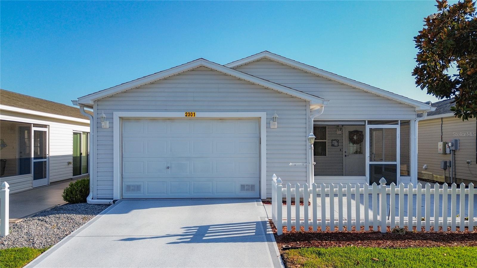 NEW LISTING!  Lovely WELL MAINTAINED Colony Patio Villa WITH VOLUME  CEILINGS between 466 and 466A in Rainey Villas in the Village of Lynnhaven.  BOND PAID, NEW ROOF 2022, ALL NEW STAINLESS APPLIANCES, HVAC 2019, NEW FLOORING 2025, TANKLESS WATER HEATER 2024,  REVERSE OSMOSIS WATER SYSTEM,  3 SOLAR TUBES WITH NIGHT LIGHT FEATURE, EPOXY COATED GARAGE FLOOR  AND LANAI FLOOR. DECORATIVE PAINTED DRIVEWAY AND PATIO.  NEW WAHSER & DRYER. NEW SLIDER.   Partially furnished.  Nicley  landscaped with plenty of patio for outdoor entertaining or BBQing!  Close to shopping on 466 or short golf cart ride to Lake Sumter Landing for nightly entertainment. BONUS you are only a 2 min drive to Lake Miona recreational Park where you can take advantage of all the Lake has to enjoy.  Not all Patio Villas are as well maintained as this one so Don't miss out on a great house that you can make a HOME full time, part time or as a Seasonal Rental Property and let it pay for itself!  Call today for a personal showing before this one is gone!