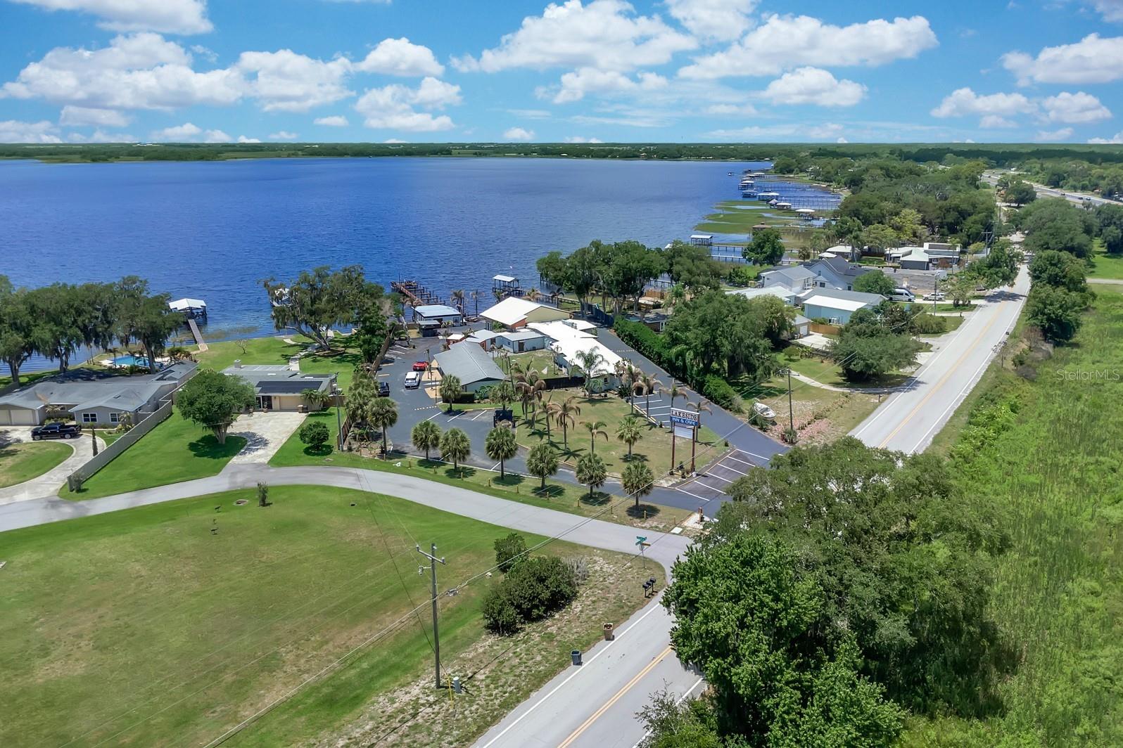 Check out this cozy hotel/cafe with approximately 176' of waterfront on Alligator Lake. There are plenty of possibilities on this property, you must see to appreciate. Located in the fast growing city of St. Cloud, this property features a total of 4 buildings: one building with lobby area, a second building with a kitchen/cafe area, a separate area with a total of 10 bedrooms with baths (one building features 5 units with 2 bedrooms each and a separate building features 5 units with 1 bedroom each), and a covered lounge/pavilion area where you can enjoy the relaxing water view during the day, and breathtaking sunsets in the evening. There is a boat dock/ramp area to access Alligator Lake. Alligator Lake is a key part of the Alligator Chain of Lakes - connected by canals. This lake is known for fresh water fishing (largemouth bass), boating, alligator spotting, and bird watching. Also, know as the "Headwaters of the Everglades". This property is approximately 7 minutes to the eco-friendly community of Harmony and 45 minutes to Disney or Melbourne and its beaches!