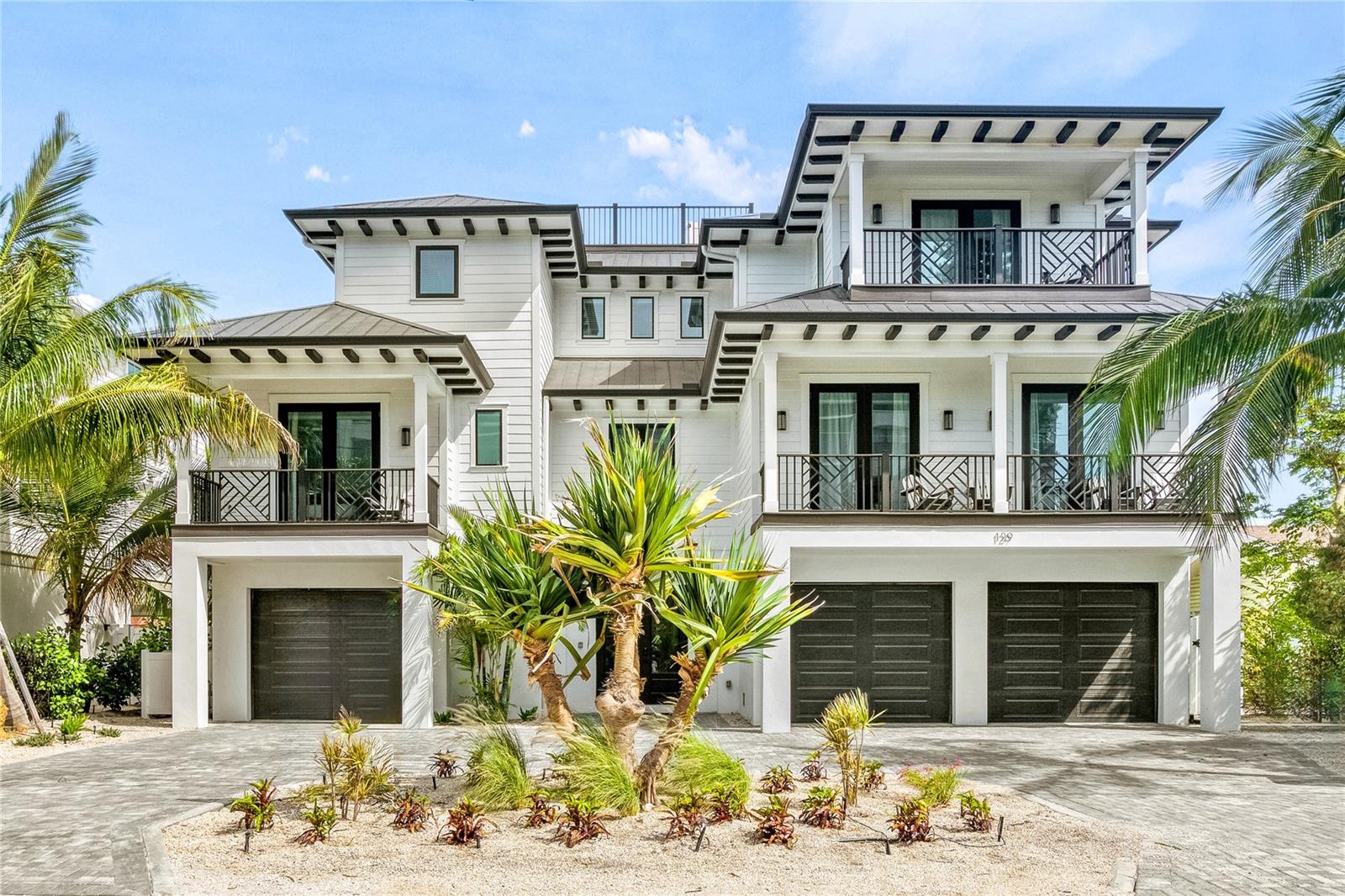 Impressive coastal luxury home featuring exquisite finishes throughout and only a block from the beach on the famous Lido Key, Sarasota. Boasting 10 bedrooms, and 12 bathrooms along with a 3 car garage, heated pool & spa this home is sure to please either a homeowner or a savvy investor looking to invest in an income producing vacation rental with a successful history. Turn key furnished and existing property management company in place already allows for a seamless transition. Awesome amenities include a waterslide, waterfall, an elevator and high end appliances. To complement the beautiful aquatic amenities, the sprawling patio features a high top bar with outdoor entertainment, a grilling area, a gaming area with a a ping pong table, and a dining area to perfect nightly entertainment on those Florida evenings. Sip your cocktails or coffee on one of the multiple private balconies or rooftop deck. This residence's prime location is just steps from the turquoise waters of Lido Beach, a 5 minute bike ride to the world famous St. Armands Circle, and a short drive to the historic downtown Sarasota. The main level features 5 guest suites, an oversized great room, and kitchen with a built-in oven, convection oven, refrigerator, and cooktop, leading to the dining room that connects to a covered balcony overlooking a tropical oasis backyard and pool/spa. Expansive 12'-14' ceilings and vast window treatments create a bright & spacious atmosphere. The third level features two master suites and three more guest suites, as well as a den featuring a stainless-steel wet bar. This home is the epitome of elegance, with intricate attention to detail on finishes and furnishings to ensure a luxurious experience.
