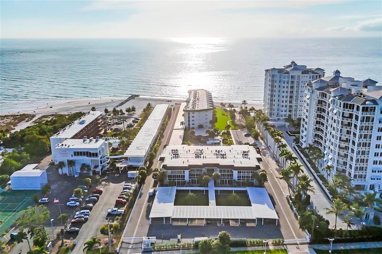 Fully remodeled beach condo offered at an incredible value. This beautifully updated unit features a completely redesigned kitchen with custom wood cabinetry, glass display doors, wine rack, quartz countertops, stainless steel appliances, subway tile backsplash, and breakfast bar. Both the guest and owner’s bathrooms have been fully renovated with modern finishes. Additional upgrades include luxury vinyl plank flooring throughout, new paint and trim, updated doors, and stylish fans and light fixtures. The unit welcomes you with a convenient dry bar at the entry and includes its own in-unit washer and dryer. Enjoy abundant natural light from impact-rated windows and a glass-enclosed lanai overlooking the pool, with a peek of the Gulf. Offered turnkey furnished, this condo is tastefully decorated and move-in ready.
Ample storage with two dedicated spaces—one on the enclosed lanai and another in the association storage room—perfect for beach gear. Located in Lido Harbour South, an intimate 69-unit community with direct beach access, residents enjoy a heated pool, clubhouse, beach deck, and assigned covered parking. Ideally situated just minutes from St. Armands Circle and downtown Sarasota’s vibrant dining, shopping, and cultural scene. Adjacent to Ted Sperling Park, offering kayaking and paddleboarding through scenic mangrove tunnels, nature trails, and frequent wildlife sightings including dolphins, manatees, shorebirds, and occasional sea turtle nests.

Schedule your private showing today!