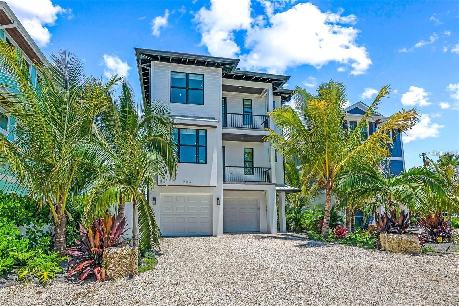 A rare opportunity to own one of the most impressive bayfront estates on Anna Maria Island, where panoramic water views, refined coastal architecture, and island living come together in a truly unforgettable setting. This exceptional 8 bedroom, 8.5 bath home offers more than 3,500 sq ft of luxury living directly on the bay in Bradenton Beach, delivering an unmatched combination of elevated modern design, premium construction, and the quintessential Island lifestyle. Floor-to-ceiling windows showcase sweeping open-water views and bring natural light into the spacious living and dining areas, while the gourmet kitchen features quartz countertops, custom cabinetry, high-end appliances, and a large entertaining island ideal for gathering with family and guests. Multiple balconies and outdoor living spaces create a seamless indoor-outdoor flow, capturing sunrise views over the bay and cooling sea breezes throughout the day. The outdoor experience is resort-like, with a private pool overlooking the water, generous covered seating areas for shaded relaxation, and direct waterfront access for paddleboards or boating enjoyment. A rooftop deck provides dramatic panoramic views of the Intracoastal and skyline, making it an unforgettable setting for sunset evenings and waterfront entertaining. The property is topped with a metal roof and built to modern coastal standards for durability and peace of mind. Each of the eight bedrooms is designed as an en-suite or semi en-suite, offering exceptional comfort and privacy for guests. The layout accommodates large families and group gatherings with ease, while still feeling private and thoughtfully planned. An elevator makes moving between floors effortless for residence and guests. Currently operated as a luxury vacation rental with strong income history and bookings in place, the home offers both exceptional lifestyle appeal and proven rental performance. Situated on one of the most desirable stretches of Bradenton Beach, this residence embodies the reason waterfront ownership on Anna Maria Island is so sought-after — a rare opportunity to live directly on the bay while being just a few blocks from the Gulf shoreline, island dining, beach markets, boutique shopping, and the relaxed coastal character that defines life on AMI.