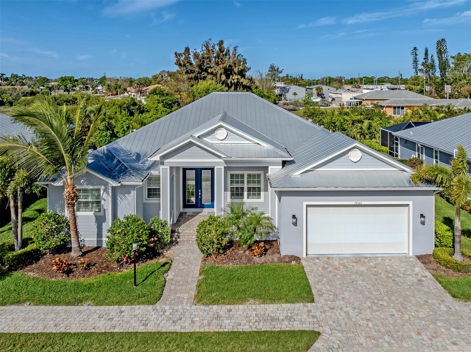 Welcome to Cottages on Curry Creek, a gated enclave of just 12 Key West-style residences in the heart of Nokomis. Built in 2017, this three-bedroom, two bath home offers 2,257 square feet under air and a thoughtfully designed great room floor plan suited for everyday living and entertaining. The kitchen is positioned at the center of the home and features an oversized island that provides ample workspace and seating. The open layout connects seamlessly to the main living areas and extends to the screened lanai, creating a cohesive indoor-outdoor experience. Outdoor living is enhanced by a private pool and spa, along with a fully equipped outdoor kitchen and fireplace designed for dining and gathering. The property includes a 25-foot shared dock on a protected saltwater canal, offering direct access for boating and waterfront enjoyment. Additional features include a two-car garage and a well-maintained setting within a limited collection of residences. The location provides convenient access to Gulf beaches, local dining and shopping, Sarasota Memorial Hospital south campus and Interstate 75.