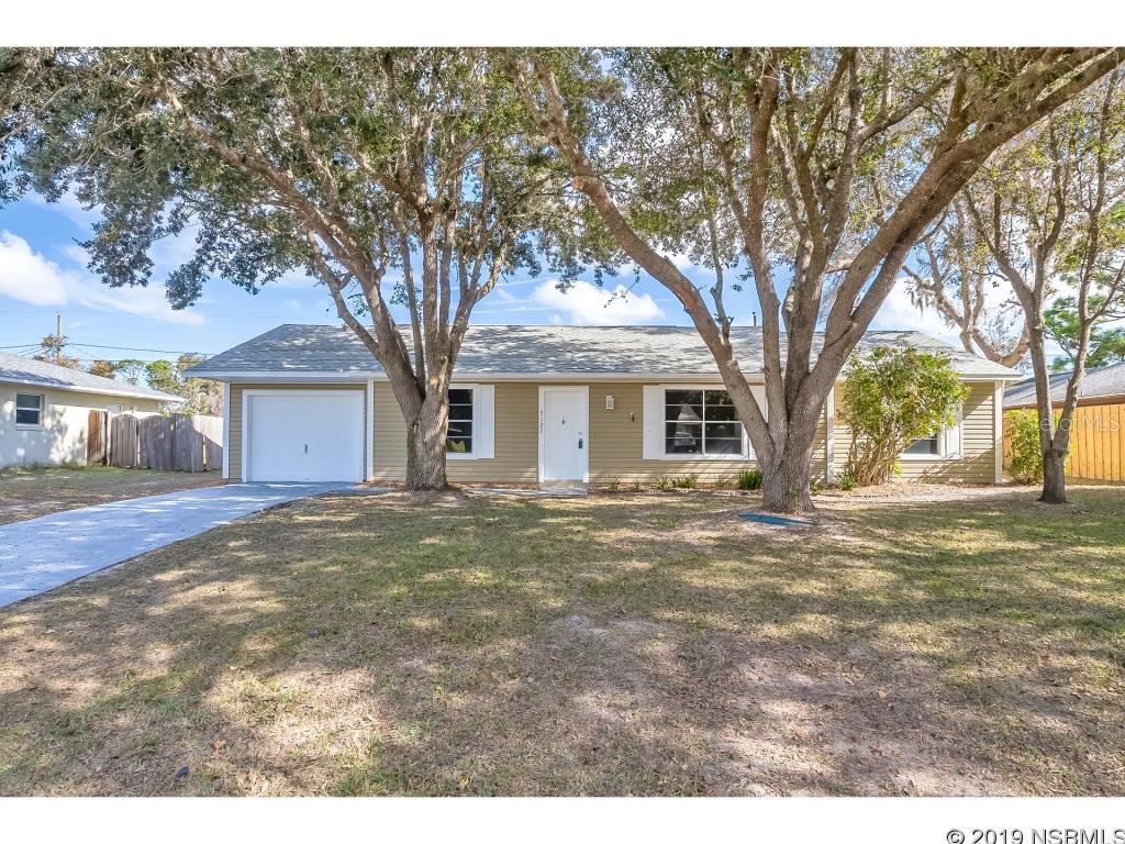 Check out this newly renovated 3/2 with brand new kitchen overlooking the open living/dining areas. New interior and exterior paint, new appliances, new flooring and new ceiling fans and light fixtures. The additional oversized garage door has an opening of 8 x 16 so extra wide space with workshop area for total 480 sq ft of parking and workspace. This is perfect for the handyman/mechanic or crafts person in your home and or the storage of work related equipment or that special automobile you love to baby. This home  sits east/west so lots of sun and beautiful front yard trees for shade. Property is privacy fenced across the back and sides for ez backyard entry to the large garage/workshop. Extra garage door is 8 x 16. It's very private in the back. Close to shopping, restaurants, elementary school, the new park and quick access to I-95 and US 1. ;Water: City