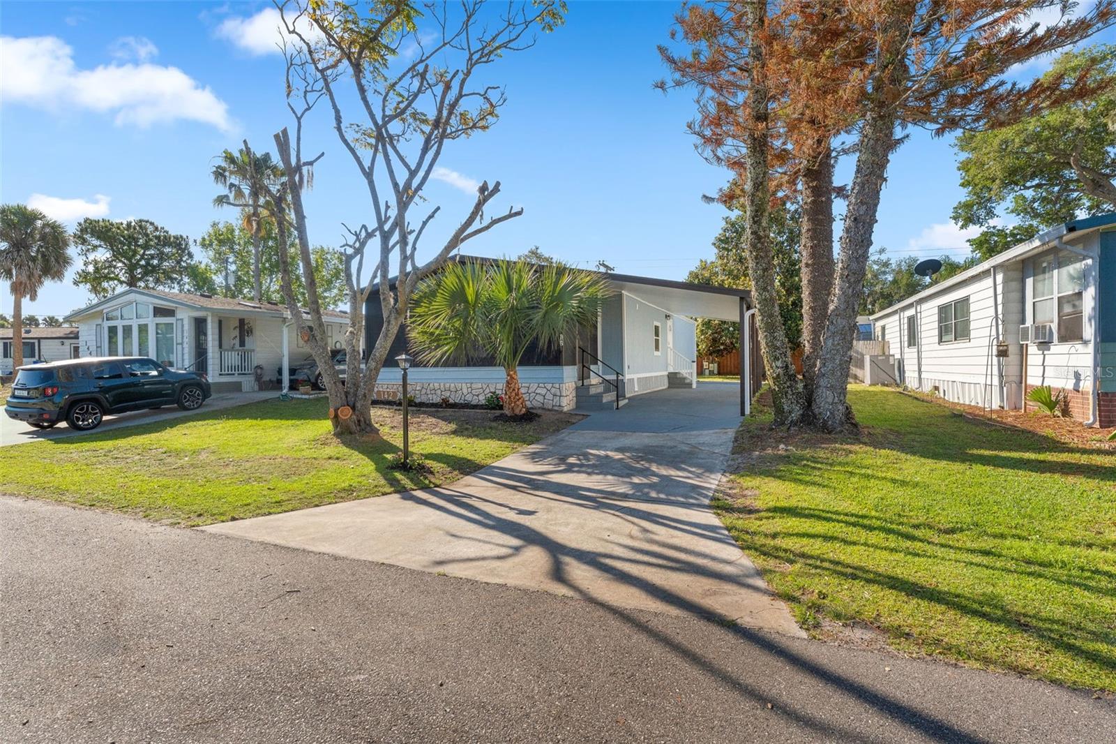 One or more photo(s) has been virtually staged. Why rent when you can own your own land and step into a home that feels completely brand new? This beautifully remodeled 2-bedroom, 2-bath double-wide manufactured home offers one of the most sought-after advantages in affordable housing, you own the lot, with low Hoa fee. . Inside, everything has been thoughtfully updated from top to bottom. The home features **all-new drywall throughout—no paneling, creating a clean, modern feel that’s rare to find in this price range. Every detail has been refreshed, including **brand-new flooring, fully renovated bathrooms, and a stylish, updated interior that feels light, bright, and inviting. Behind the walls, you’ll find even more value and peace of mind with new plumbing and electrical systems, giving you confidence that the big-ticket items are already taken care of. The upgrades continue outside with new siding and windows, enhancing both curb appeal and energy efficiency, while the roof was replaced in 2022 for added durability. The kitchen comes fully equipped with new appliances, making it easy to move right in and start enjoying your space from day one. There’s nothing left to repair, replace, or renovate—this home is truly move-in ready. Whether you're a first-time buyer, downsizing, or simply ready to stop renting, this property offers a rare combination of affordability, ownership, and like-new condition.—this is an opportunity you don’t want to miss. Community amenities include 2 pools (1 heated), clubhouse, tennis, shuffleboard, bocce, RV/boat storage, private boat ramp, dock, and fishing pier