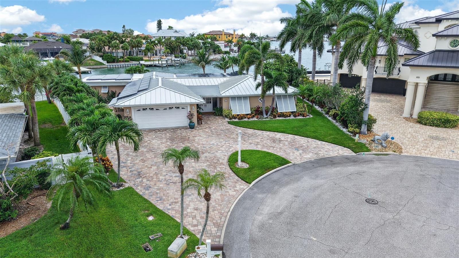 Rarely available waterfront corner lot in the coveted Tierra Verde community — this meticulously updated 3-bedroom, 3.5-bath residence delivers the ultimate Florida lifestyle. With 2,576 SF of air-conditioned living space and 3,885 SF under roof, the oversized covered patio and air-conditioned 2-car garage provide exceptional additional living and entertaining space beyond what the AC square footage reflects.

Situated on a deep-water canal with a massive sea wall, the property was fully refreshed in 2020 with a new sea wall, dock, and boat lift — making it an instant-access boater's dream. The large private pool anchors the outdoor living area, complemented by a large fireplace on a dedicated paver pad — perfect for entertaining under the stars. Serene water views surround you from virtually every angle.

Inside, the open floor plan has been transformed with a fully updated kitchen, renovated bathrooms throughout, and refined finishes that honor the home's mid-century bones while delivering a contemporary feel. Peace of mind comes standard with a brand-new standing seam metal roof installed in 2025, a new paver driveway (2020), and all major water infrastructure — sea wall, dock, and boat lift — replaced in 2020.

Tierra Verde is a highly sought-after island community minutes from Fort De Soto Park, Passa-Grille Beach, and St. Pete Beach — with easy access to downtown St. Petersburg and Tampa. Live where others vacation. Hurricane-rated storm shutters covering every window and door were installed in 2022, providing exceptional storm protection and insurance benefits.