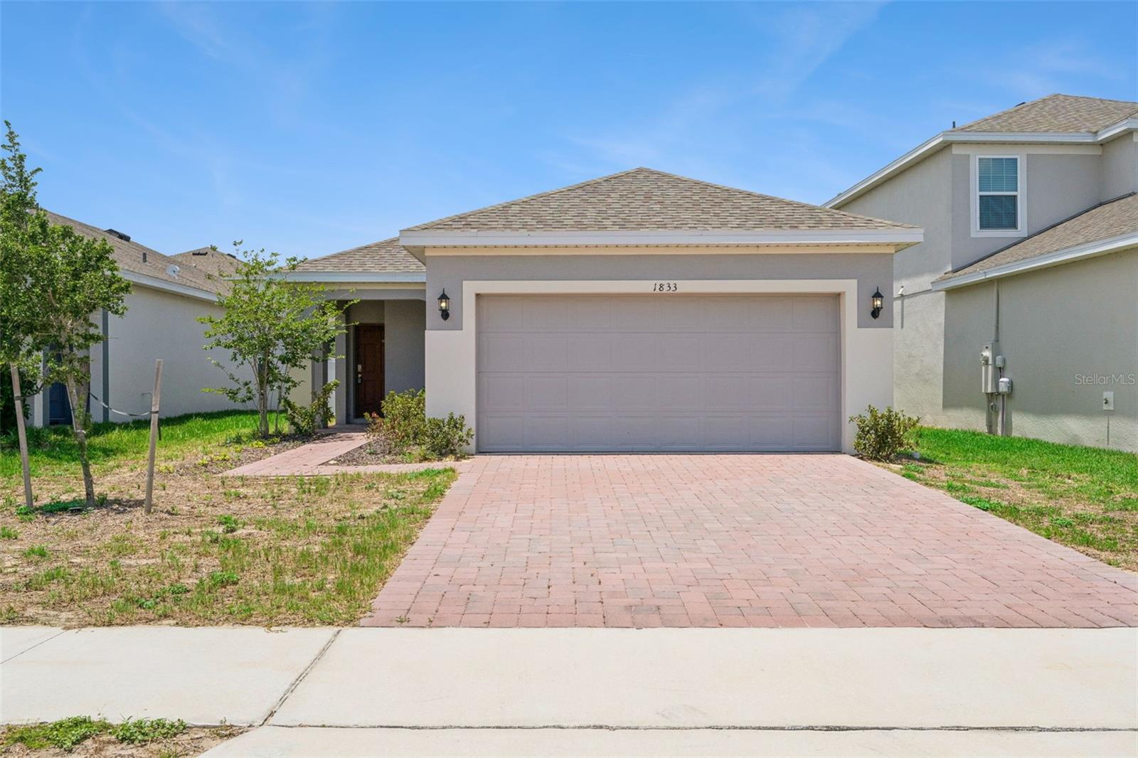 Short Sale. Don't miss this opportunity to own a beautifully maintained, move-in ready home in the highly desirable Trinity Lakes community of
Groveland. Built in 2023, this 4-bedroom, 2-bath Delray model offers modern design, energy-efficient construction, and a functional open-concept layout designed for today's lifestyle. The spacious kitchen overlooks the main living and dining areas and features 42" upper cabinets with crown molding, stainless steel appliances, generous counter space, and abundant storage. Tile flooring throughout the main living areas adds both style and durability, while the split-bedroom floor plan provides privacy and flexibility for families, guests, or a home office. Step outside to the covered lanai overlooking the fully fenced backyard, creating the perfect space for pets, play, outdoor gatherings, or simply enjoying your own private outdoor retreat. This home is in great condition and offers the peace of mind that comes with newer construction, including smart home technology and energy-saving features. Additional highlights include a 2-car garage, brick paver driveway, and a backyard already fenced for added privacy and convenience. Residents of Trinity Lakes enjoy access to outstanding community amenities including a resort-style pool, splash pad, fitness center, playground, fishing dock, and scenic walking paths. Conveniently located near shopping, dining, and major roadways including US-27 and the Florida Turnpike, providing easy access to Clermont, Orlando, and beyond. Whether you're searching for your first home, your next home, or a newer property in a growing Central Florida community, this move-in ready opportunity deserves a place at the top of your list.