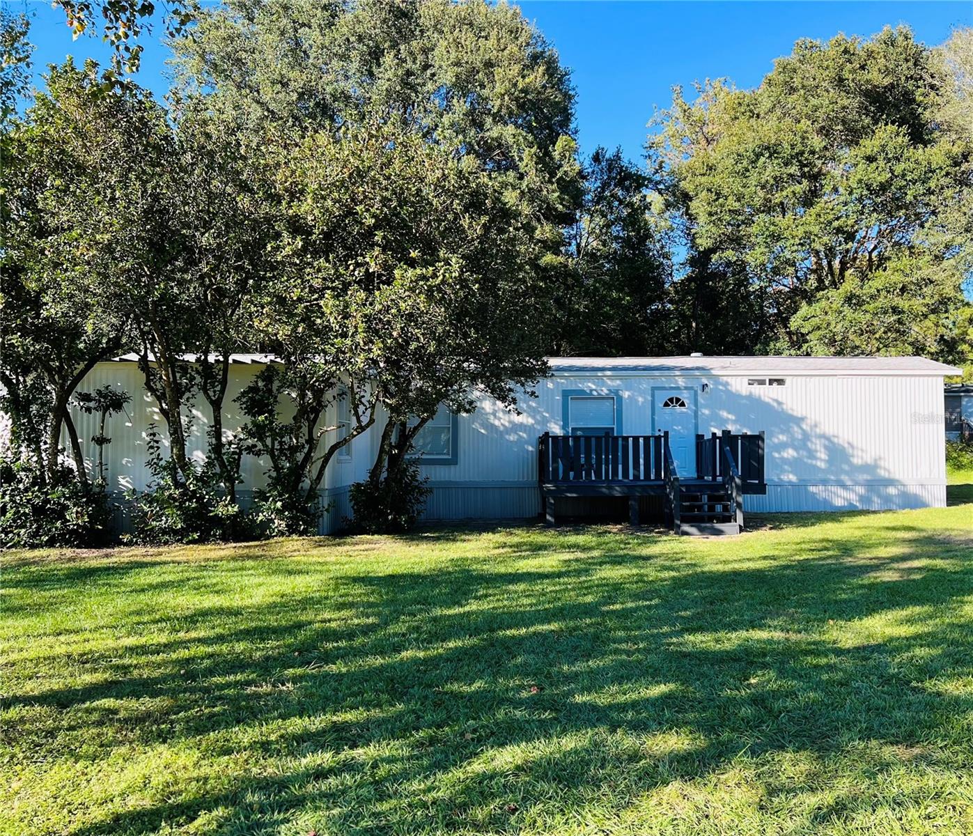 Discover your dream near-lakeside sanctuary just moments from the Carney Island Boat Ramp. This exquisite 2-bedroom, 2-bathroom home opens the door to one of Marion County's most sought-after treasures: the breathtaking Lake Weir.

Stepping inside, you'll be embraced by a meticulously refreshed space exuding modern comfort. The heart of the home showcases a contemporary kitchen with gleaming appliances and chic cabinetry, enhancing your culinary experience.

For your comfort, a brand-new air conditioning system was expertly installed in September 2023, ensuring year-round bliss, even in the Florida warmth.

But the magic of this property extends beyond its walls. You'll find yourself in close proximity to the historic Ma Barker home, a slice of local history. What's more, this haven is conveniently situated just 10 minutes from The Villages, offering abundant shopping, dining, and recreation options.

Imagine your mornings: a leisurely stroll to the Carney Island Boat Ramp, granting you direct access to the tranquil waters of Lake Weir. Don't forget to bring your boat and fishing gear, as this is where aquatic adventures come to life. Whether it's the thrill of casting a line or the serenity of boating, your desires are just moments away.

And here's a bonus: there is No HOA, giving you even more freedom to enjoy your property your way.

If you've been yearning for a near-lakeside lifestyle that combines comfort and convenience, seize this opportunity. Your near-lakeside oasis awaits, promising a life filled with tranquility, history, and boundless recreational pleasures. Experience lakeside living like never before – your dream is just a visit away. Hurry and reel in this home!
