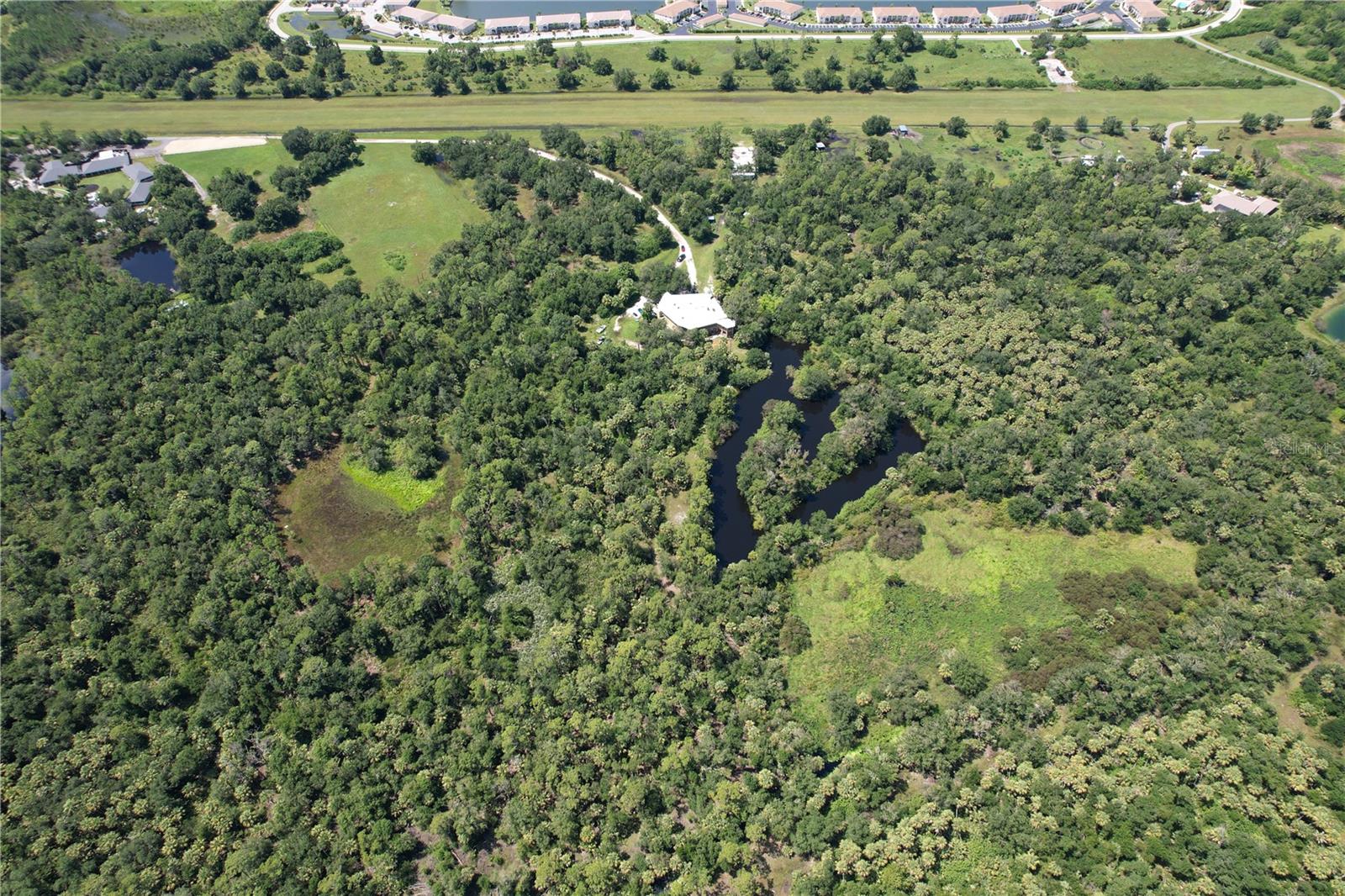 ~50 Acre Private Airport & Equestrian Estate – SW Florida | AIRPORT CODE: 20FL

Property Description / Public Remarks

Nearly 50 acres on a private airport property (20FL) in SW Florida—just minutes from I-75. This estate is an aviation and equestrian lover’s dream, combining a private airstrip, horse/livestock potential, and luxury redevelopment possibilities.

Key Features:

Runway & Aviation Infrastructure
 • 3,800' grass strip runway
 • 50' x 100' concrete pad ready for hangar
 • Airport membership is voluntary; details available

Main Residence – 10,000 sq. ft. (Unfinished)
 • Brick + poured-concrete construction with durable metal roof
 • Partially finished — ideal to complete as a private residence, retreat, or venue

Natural & Landscape Features
 • Multiple lakes and a private island
 • Undisturbed, scenic terrain for privacy and event settings

Outbuildings & Utility Structures
 • Large pole barn suitable for storage, equipment, or agricultural uses
 • Fully fenced perimeter

Zoning, Use & Development Potential
 • Zoned Agricultural — supports equestrian, farming, livestock, or tax-benefit use
 • Future Land Use: RSF-1 — opens opportunity for residential subdivision
 • Flexible possibilities — private aviation estate, boutique event venue, equestrian retreat, private homesites

Location & Lifestyle
 • Minutes from interstate access
 • In a region framed by upscale golf communities and luxury amenities
 • Ideal for buyers seeking both aviation convenience and equestrian/ farm lifestyle