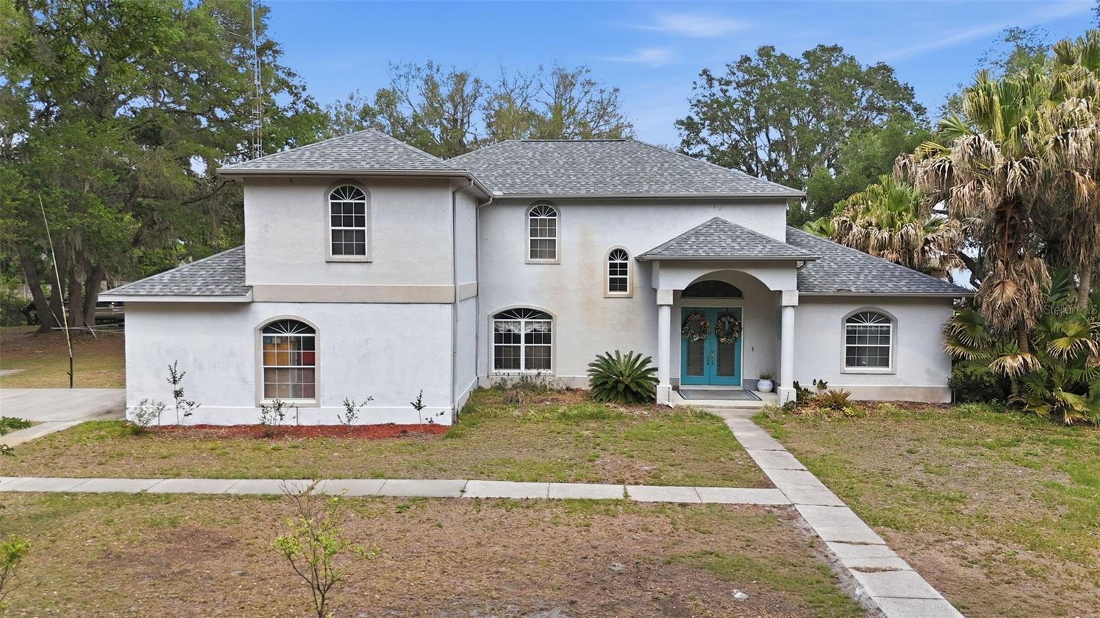 Welcome to this stunning 4-bedroom, 3-bath home in Summerfield, offering direct canal access to the lagoon and Lake Weir—perfect for boating enthusiasts. Spend your days cruising to Eaton’s Beach or entertaining at home in your private media room. This property has outstanding curb appeal; you will be greeted by the mature oak trees and private gate. Inside, you’ll find an open floor plan with vaulted ceilings and abundant natural light. The spacious kitchen features maple cabinetry, an island/breakfast bar, stainless steel appliances, and a closet pantry. The living room showcases high ceilings and seamless flow for entertaining. The primary suite and one of the bedrooms are located on the main floor. The primary bedroom has a tray ceiling, walk-in closet, and a luxurious en-suite bath featuring a jetted garden tub, separate shower, & dual marble vanities. Upstairs, the two guest bedrooms share a full bath, offering comfort and privacy for family or visitors. The indoor laundry room includes a utility sink and additional storage. Additional highlights include a side-entry two-car garage and a screened-in pool—perfect for enjoying Florida’s warm weather year-round. This home truly has it all—schedule your private showing today!