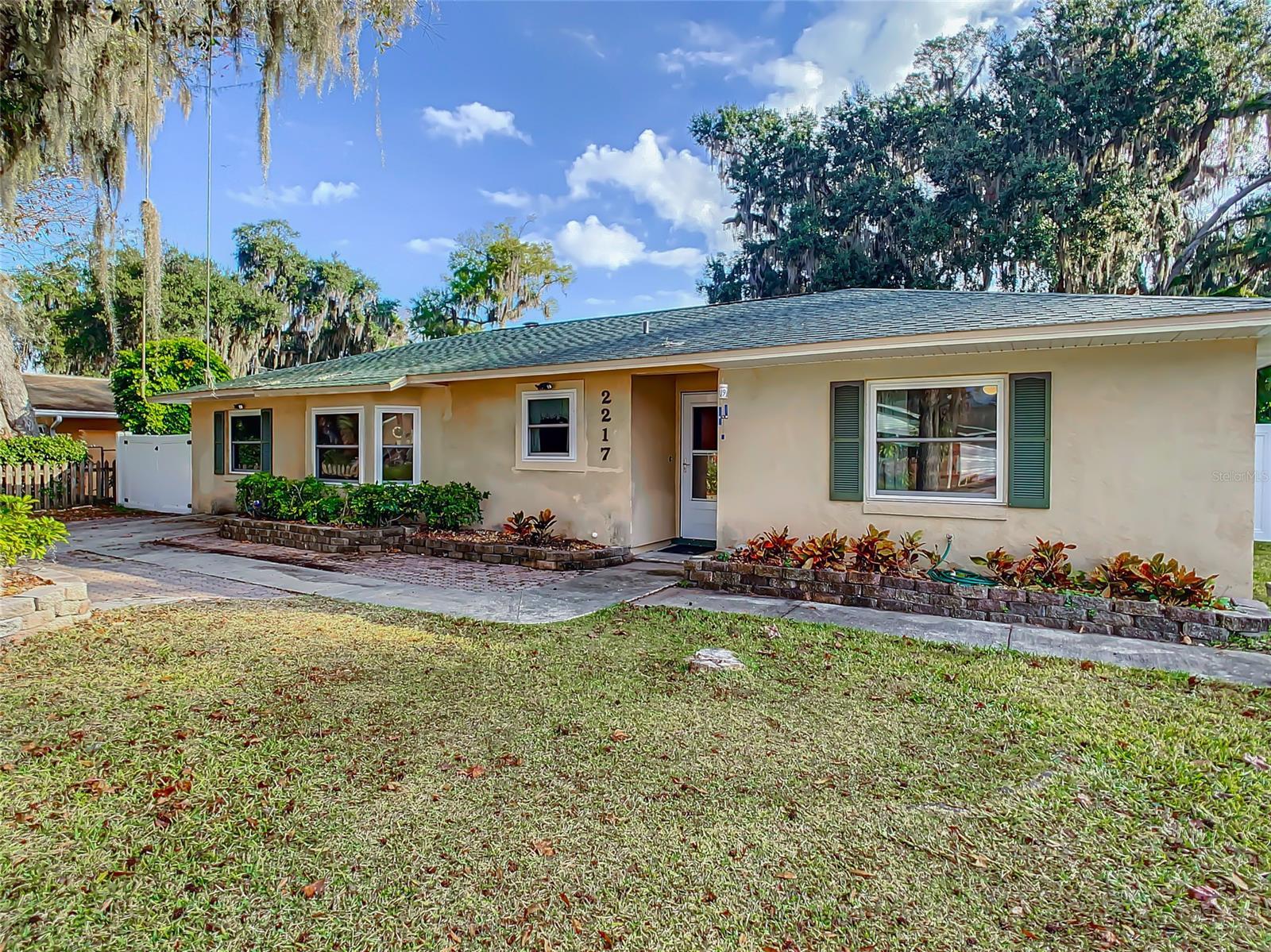 Look at the details!!  Concrete Stucco tucked on a POSTCARD LOT and setting ,  laminate and tile floors.  ROOF is 4 YEARS +- , HVAC is 8 YEARS +, WATER HEATER 3 years...  !  Private with a looks like new white vinyl fence!!  Century oak trees tucked perfectly at the southeast corner !  504 square feet of SCREENED PORCH bookended by 180 SQ FT of OPEN PORCH ( perfect for grills and smokers and the outdoor chef will appreciate )  PLUS!! !! 884 square feet of concrete slab with FIREPIT !  FRESH NEW TONE OF SUBTLE GRAY PAINT THROUGHOUT HOUSE AND NO NAIL HOLES! , DOUBLE HUNG WINDOWS, HURRICANE COVERS FOR WINDOWS IN THE STORAGE SHED!  The Best utility room I've seen !! with door to outside is situated next to BONUS ROOM that would be ideal for the Mother-in-Law ! INDOOR FIREPLACE with solid brick wall in the GREAT LIVING ROOM .. triple french doors and double doors opening up to the screened porch! Note that double french doors open up from the master bedroom to the screened porch for fresh air.     Those gorgeous white shelves are Built In's and stay with you when you come home to this amazing cozy floor plan in a wonderful location and neighborhood !!  Convenient to I-95 just 3.8 miles away.  Just over 7 miles to drive onto New Smyrna's Beach.  Healthcare and Shopping Extremely Convenient ! ;Water: City