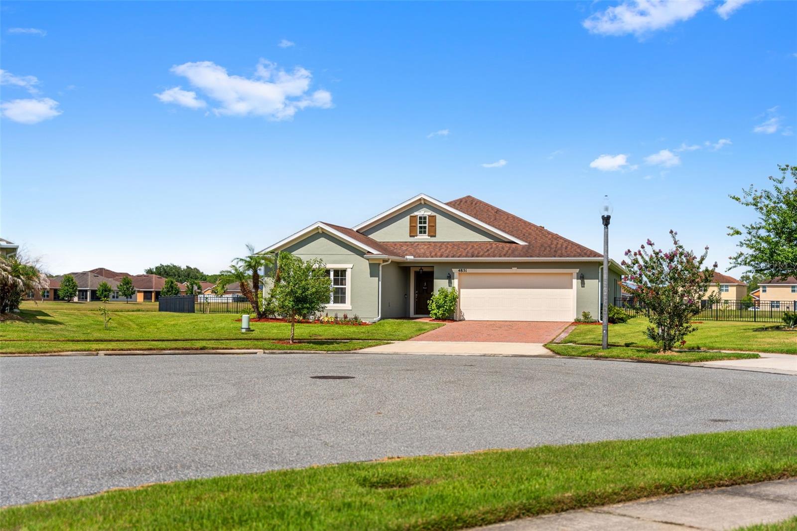 4/2 WATERFRONT HOME ON AN OVERSIZED PIE-SHAPED LOT IN WATERVIEW! Built in 2018, this beautifully maintained Conway floorplan offers approximately 2,116 sq ft and features a desirable split-bedroom layout for added privacy. The open-concept design showcases panoramic water views from nearly every room, creating a bright and inviting living space perfect for everyday living and entertaining. Upgrades include solid-surface flooring throughout, an extended screened porch, and the convenient pass-through from the laundry room to the primary closet. The spacious primary suite overlooks the water, while well-maintained landscaping enhances curb appeal. Located in the popular Waterview community, walking distance to Poinciana High School, residents enjoy a pool, clubhouse, playground, and parks, all just minutes from Disney. A brand-new Target and additional shopping and dining options nearby add even more convenience to this exceptional waterfront property.