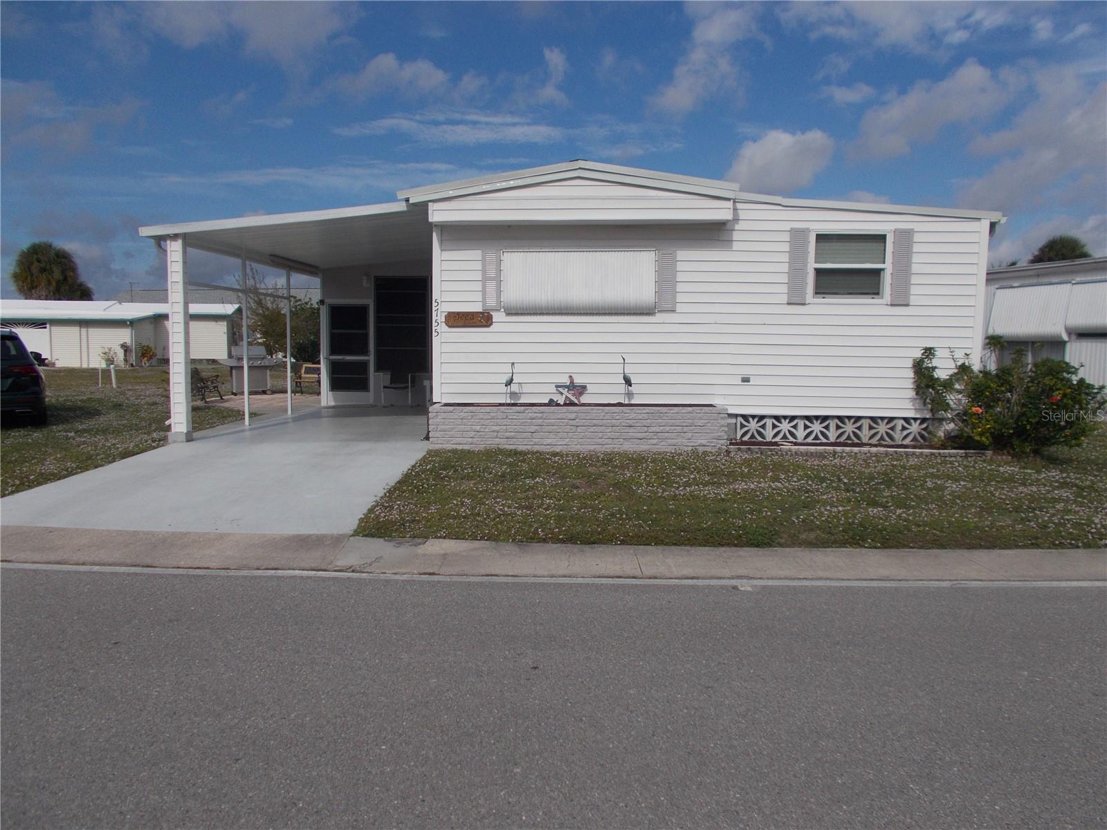 Welcome to 5755 Holiday Park Blvd., which is a 2 Bedroom, 2 Bath furnished home located in the PET SECTION.  This home has it all.  A beautiful eat-in Kitchen with laminate flooring and a Large Living Room with the same flooring.  Off the Kitchen you have a bump out which has your Bonus Room. To the right you will enter the Master Bedroom and Master Bathroom with shower.  Down the hall from the Living Room, you have Bedroom #2 and the 2nd Bathroom.  You have a large Lanai which leads into your Laundry/Workshop.  You also have a shed for your extra things.  This home has a new metal roof that was installed (as per the owner) in 2023 and except for the living room and kitchen ceiling the house has 1/2-inch drywall. The house also has Therma pane windows in all rooms except the bathrooms and the kitchen. Owner has had a 4-point inspection done on the home. In Holiday Park you own the land with a deed and your monthly maintenance charge of $195.00 ($2340.00 a year) is included in your taxes. The community features 2 clubhouses, 2 swimming pools, a library, fitness center, tennis courts, pickle ball & bocce to name a few. You are close to shopping, dining, entertainment, numerous golf courses, sports facilities, airports and SW Florida's world-renowned beaches.  Come take a look!