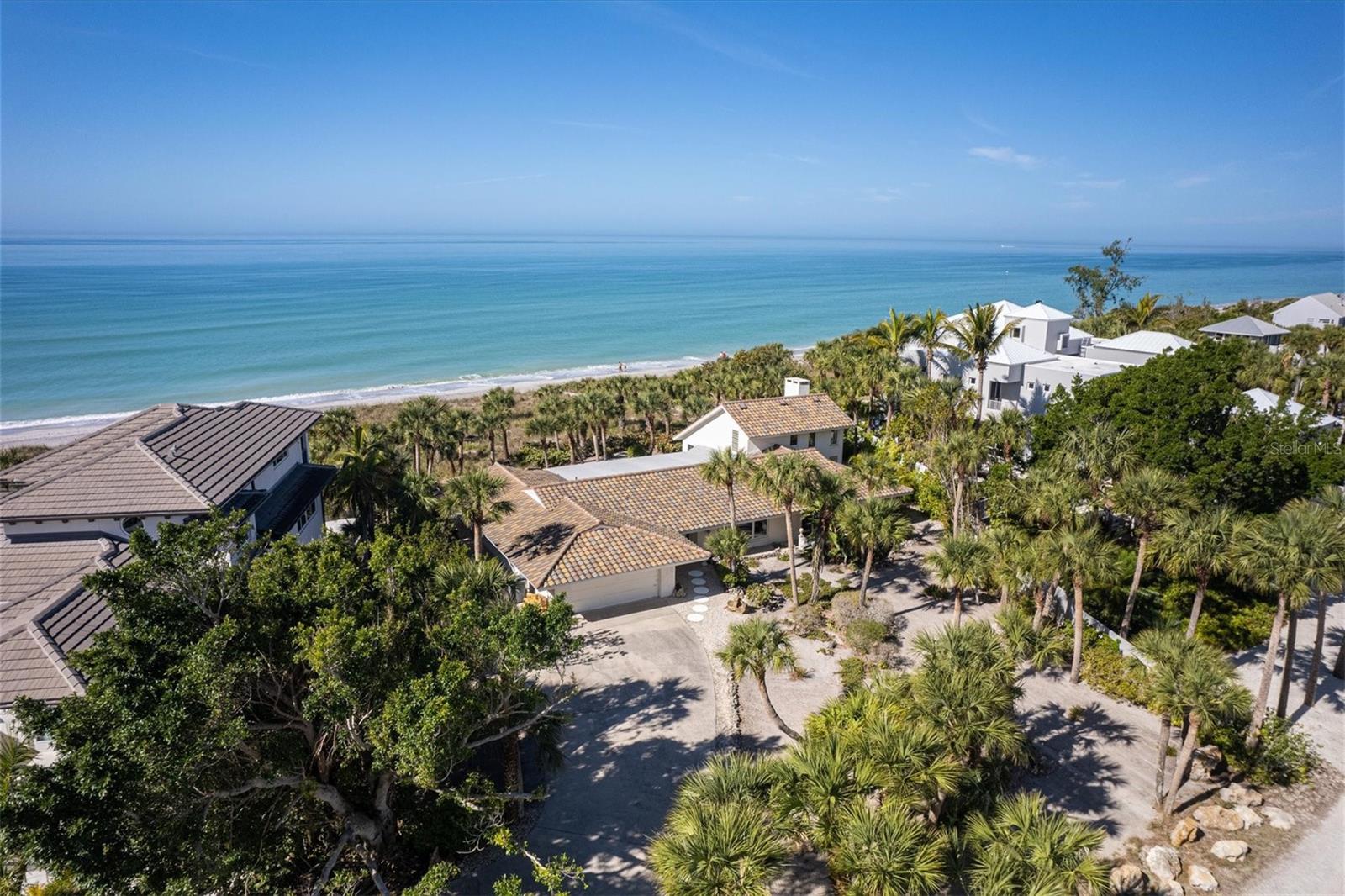 REDUCED SALES PRICE: Mid-Century residence offering your customer a spectacular residence with land from gulf to bay! A gulf front oasis that can only be described as a home that represents the classic sought-after Old Florida beach residence. This sandcastle has been built for perfection to reside year round, or to be the vacation destination for family and friend gatherings! It’s an impeccably maintained residence and landscaped ideally for the beach! Easy breezy landscaping with lots of swaying palms. The kind of landscaping that allows you the time to enjoy where you live and all that the island offers. No high cost in landscaping needed to maintain an optimum appearance year-round. You will love how a beachy tradition is blended with the sleek openness of the homes floor plans! The sun-drenched Florida room flows out to a large open-air patio. The concept creates an ease while entertaining large groups and enjoying unmatched sunsets with your friends and family! Your kitchen offers views of the gulf as well as facing to your guest while dining. There are multiple dining areas for the pleasure of your guest! The main kitchen has a counter style for casual dining. It also has area for the chef to have a small office area. The charms that this residence gives each room will make it difficult for you not to want to move right in! It will be hard to choose which room you will find more welcoming. All areas of the home are purposely designed, spaciously, peaceful and soothing for its owner’s souls. This is truly an ultimate private beach to bay residence, with glimpses of the Frank Lloyd Wright design. Including a large well-kept utility boat house with garage doors on the bay. Tremendous space for protection of your kayaks, SUP, canoes, or bikes. There is also a small boat basin on bay which makes it easy to board your water toys. The dock is equipped with a 10K boat lift. The water and electric are all in place. Home has two septic tanks. The bay side offers 150 feet of pre-cast seawall. A tremendous asset as it is restricted today to build new.
This fabulous home and boathouse are being sold fully furnished!! All this home needs is you!! The island has a private resort that would welcome your membership! It includes tennis, pickleball, Bocci, and dining. A HUB in the community! Boutiques, restaurants, and fun water sport rentals are available at the south end of the island. Two bridges onto the island for your convenience and all major mainland shopping within five miles. Optimum location to reside on Manasota Key!